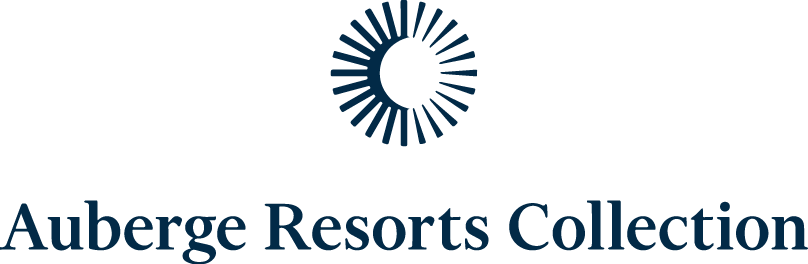 Logo of Auberge Resorts Collection featuring a sunburst design and elegant typography.