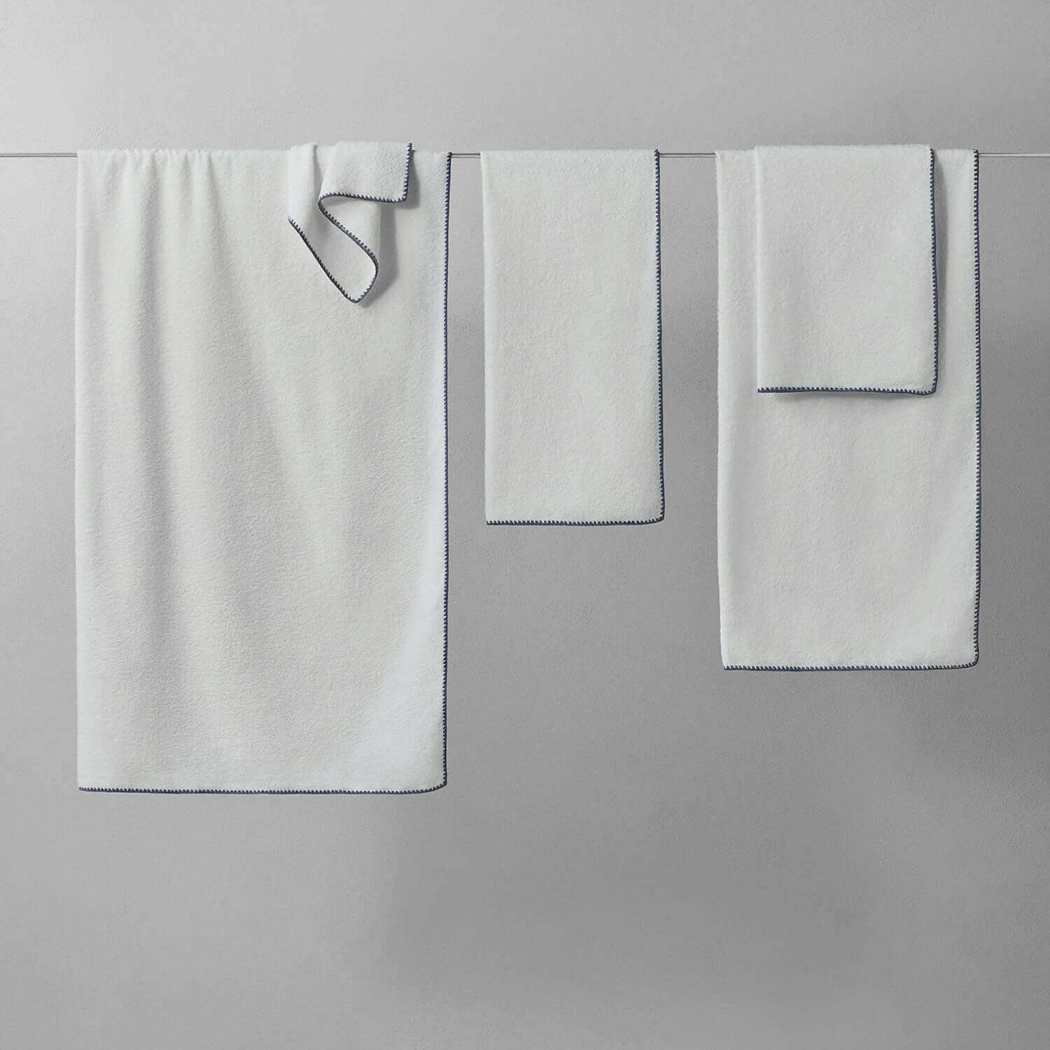 Bordado towel with grey trim, space-saving and eco-friendly, using 40% less water and electricity for washing.