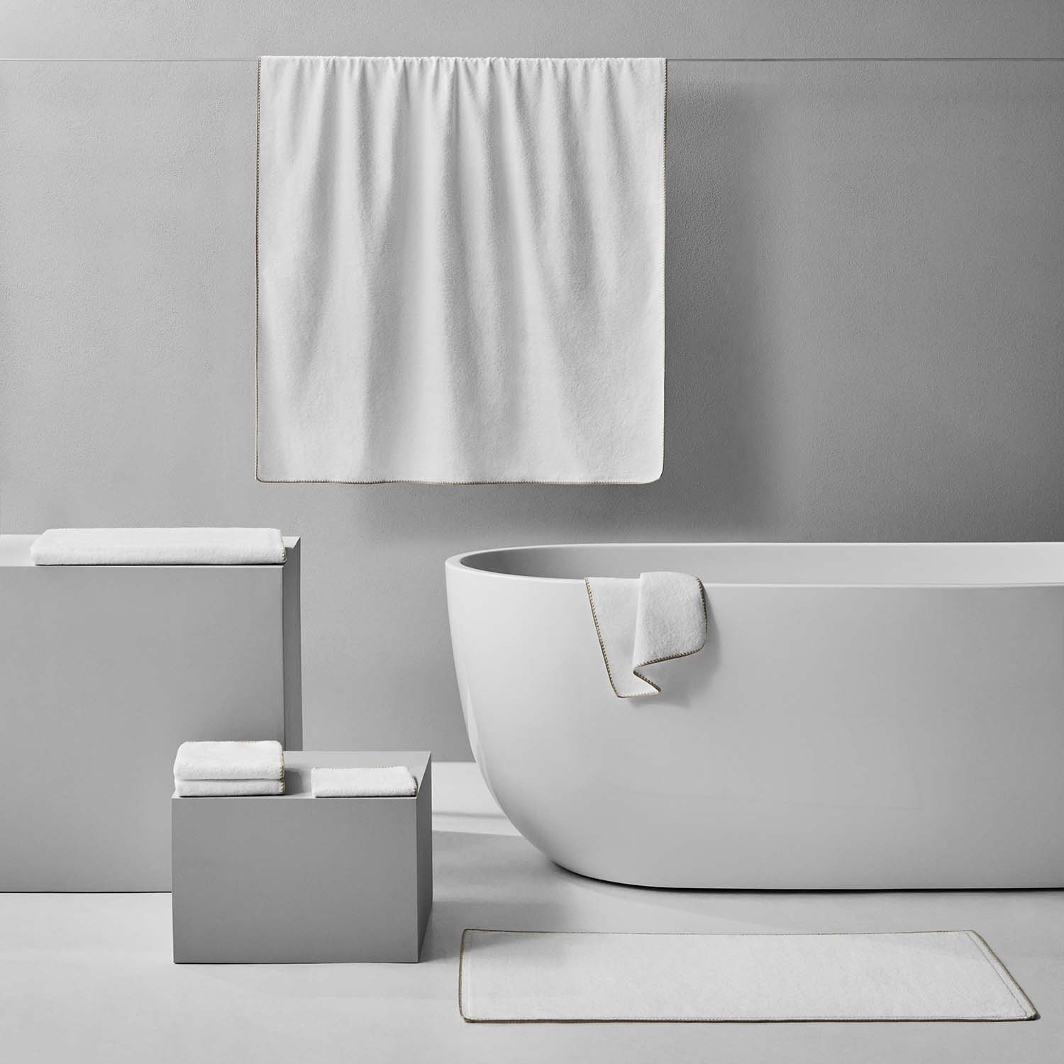 Bordado towel sand trim in modern bathroom, showcasing space-saving design and energy-efficient features.