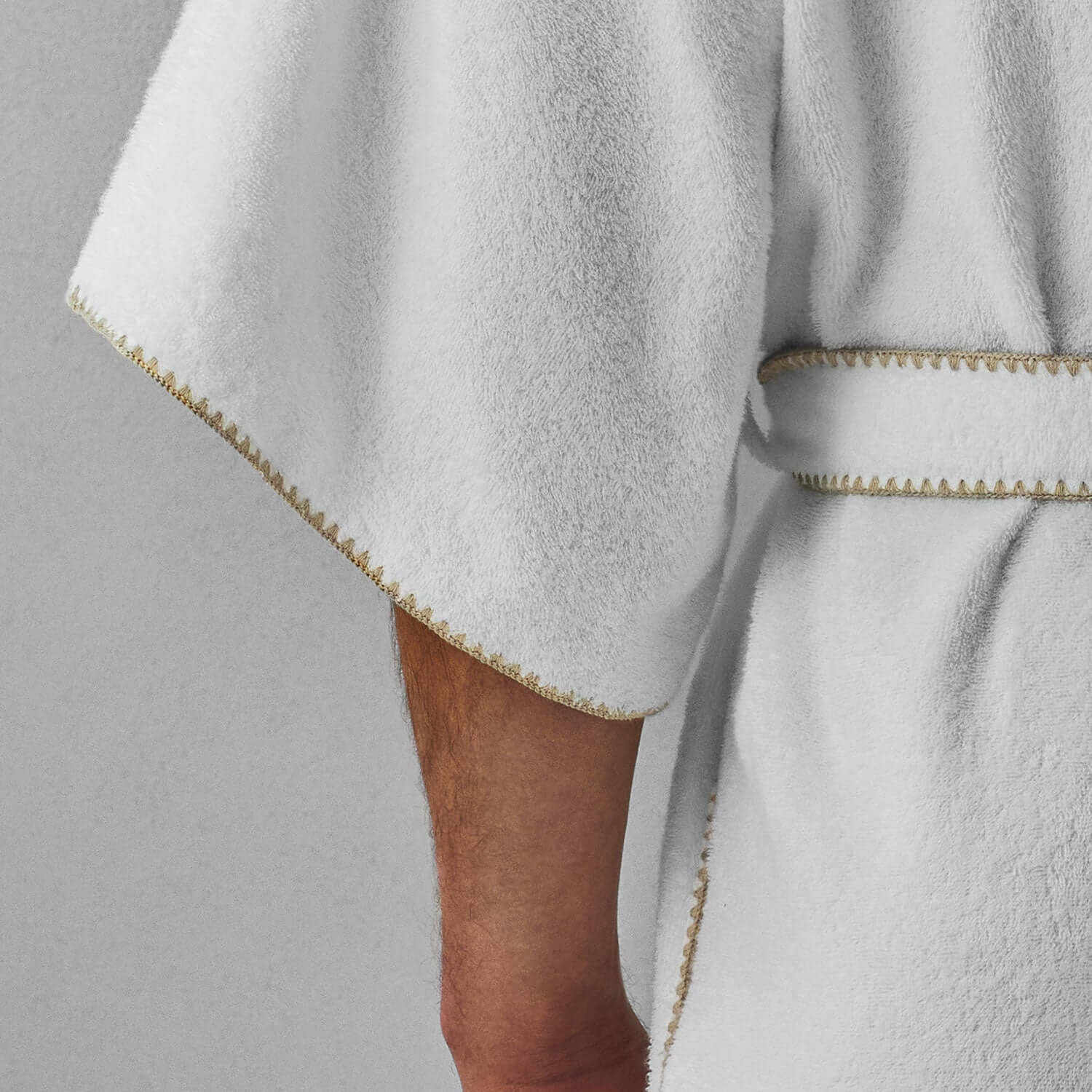 Back view of stylish white bordado hooded robe with gold trim, perfect for hotels and spas.