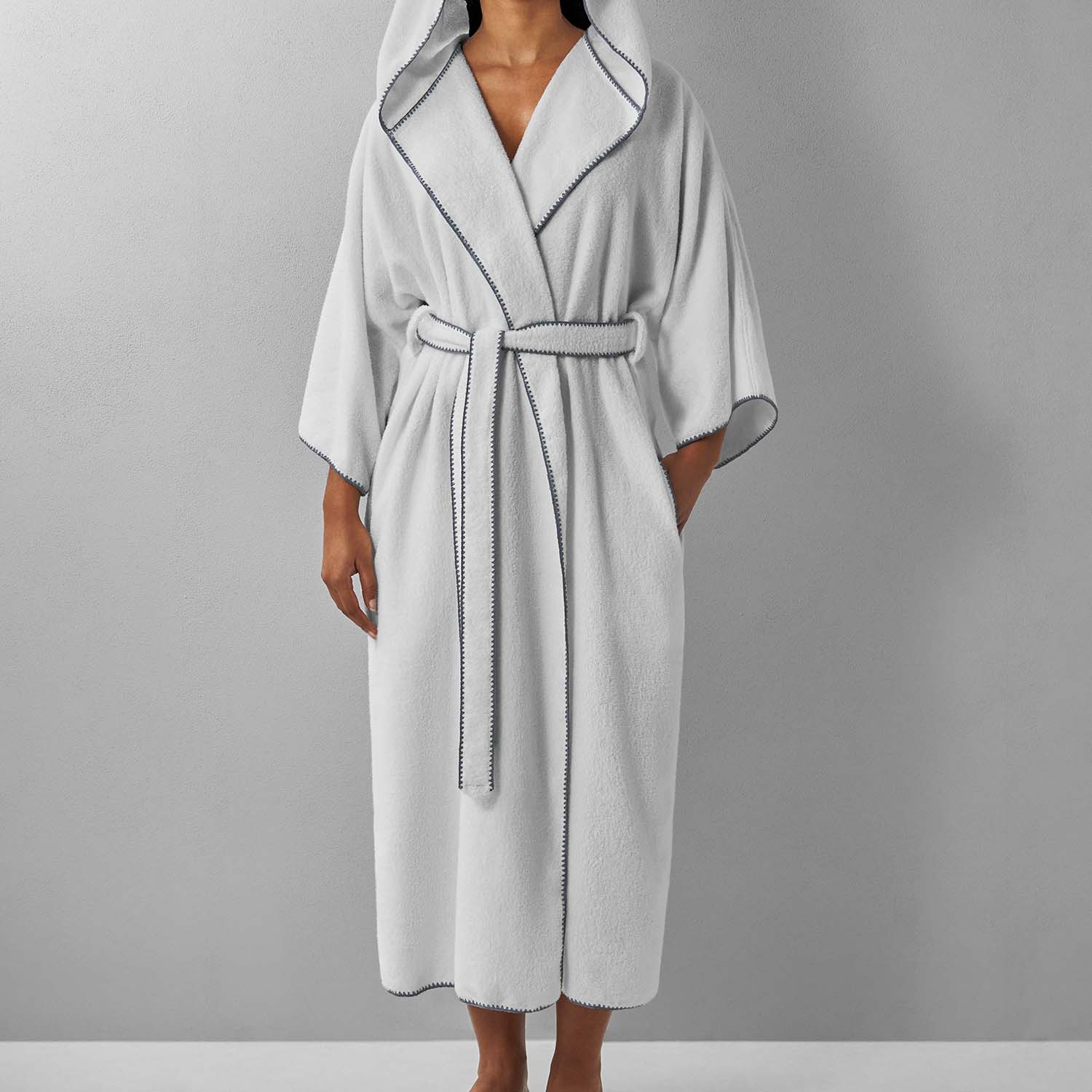 Bordado hooded gray trim robe featuring ¾ sleeves, pockets, and plush moisture-absorbent fabric.