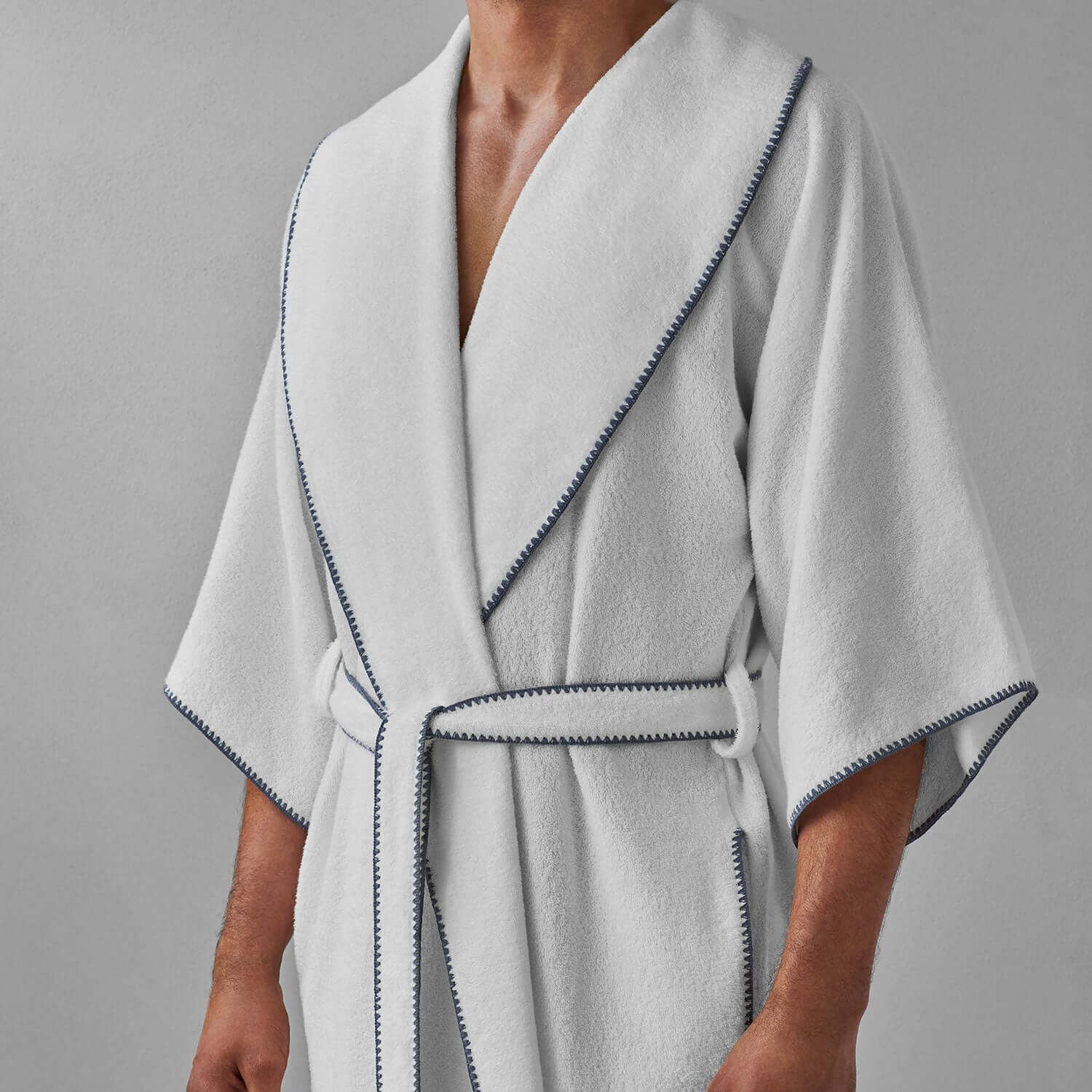 Gray trim shawl-collar robe featuring plush weave, lightweight comfort, and stylish self-tie belt. Ideal for lounging.