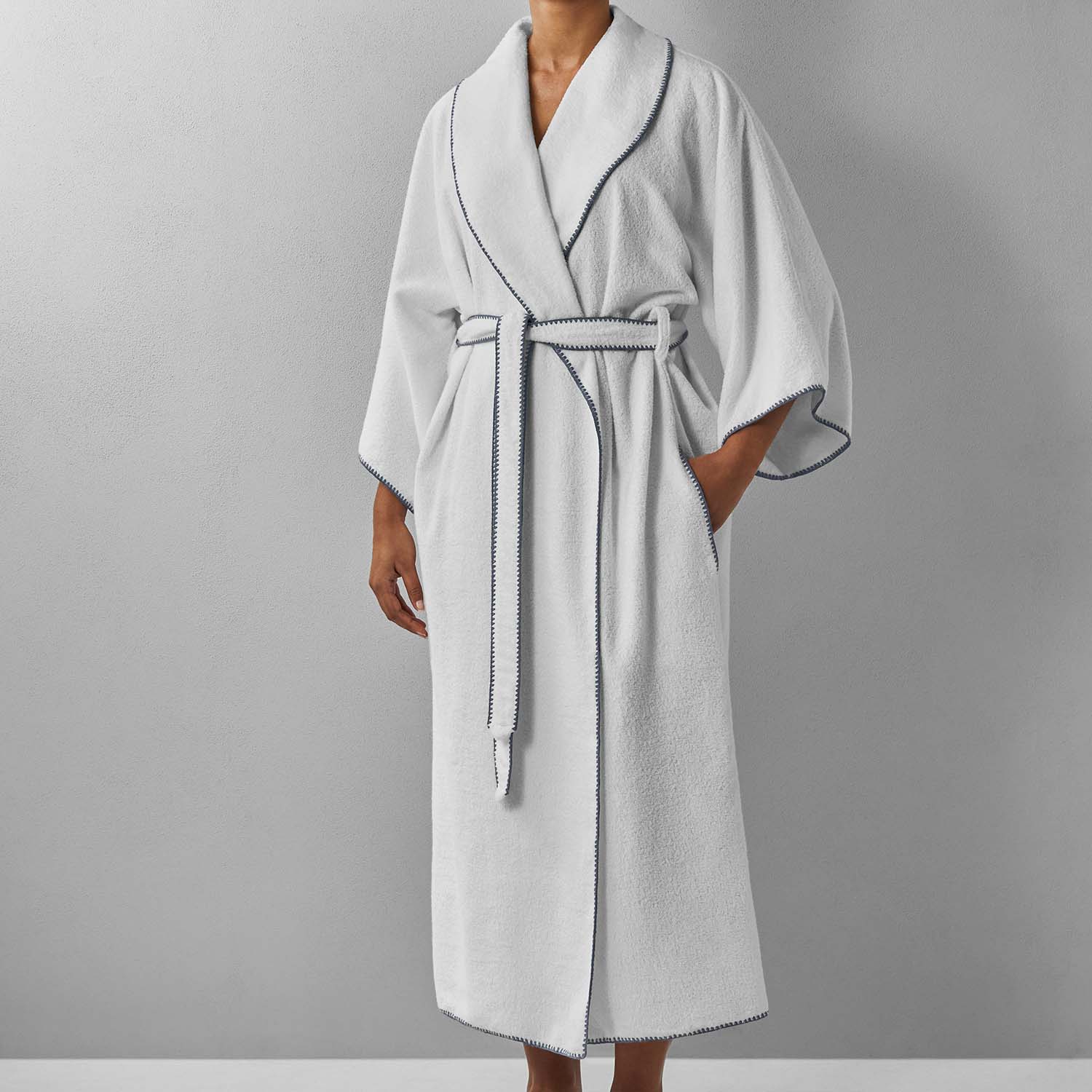 Modern Bordado shawl with gray trim, lightweight, plush weave, perfect for comfort and style in any setting.