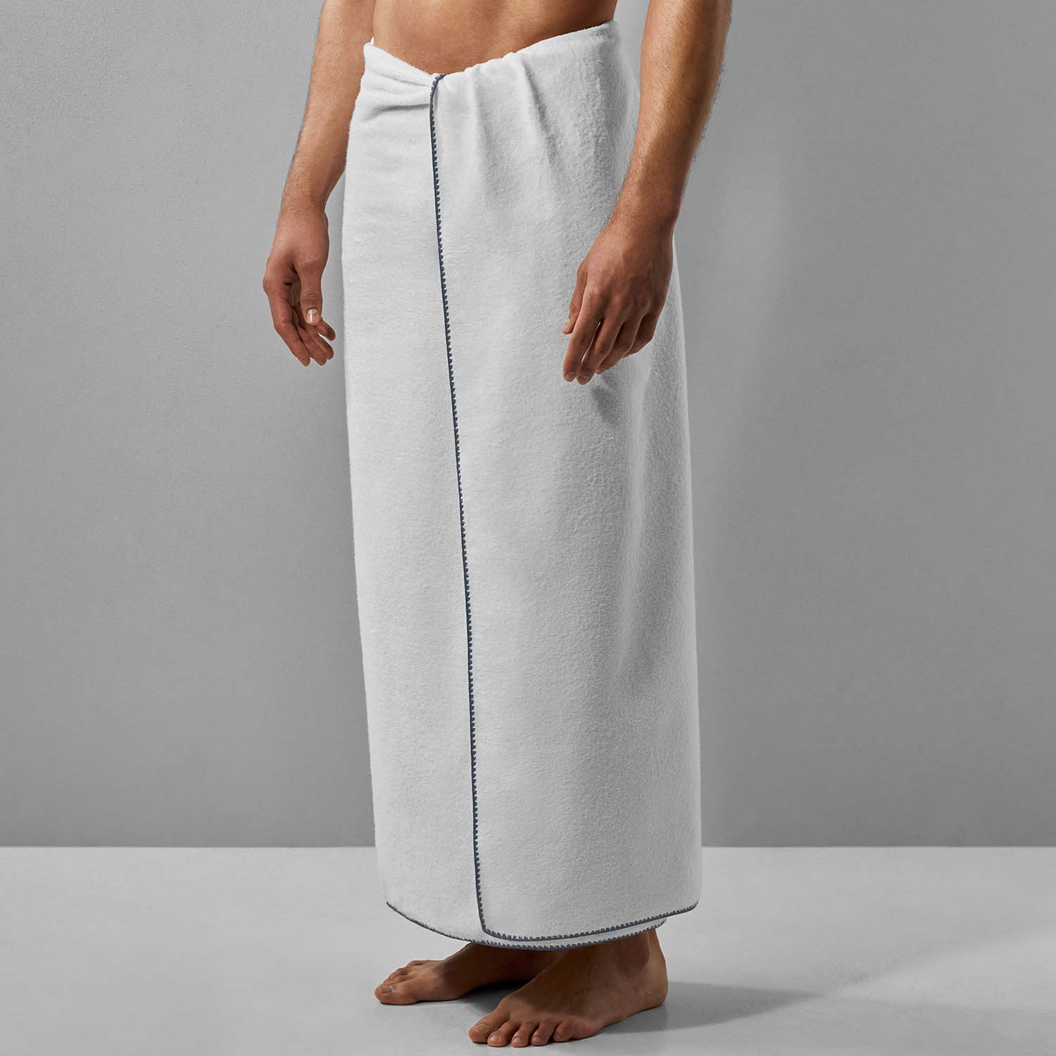 Bordado towel with grey trim, a thin plush space-saving option that requires less water and storage.
