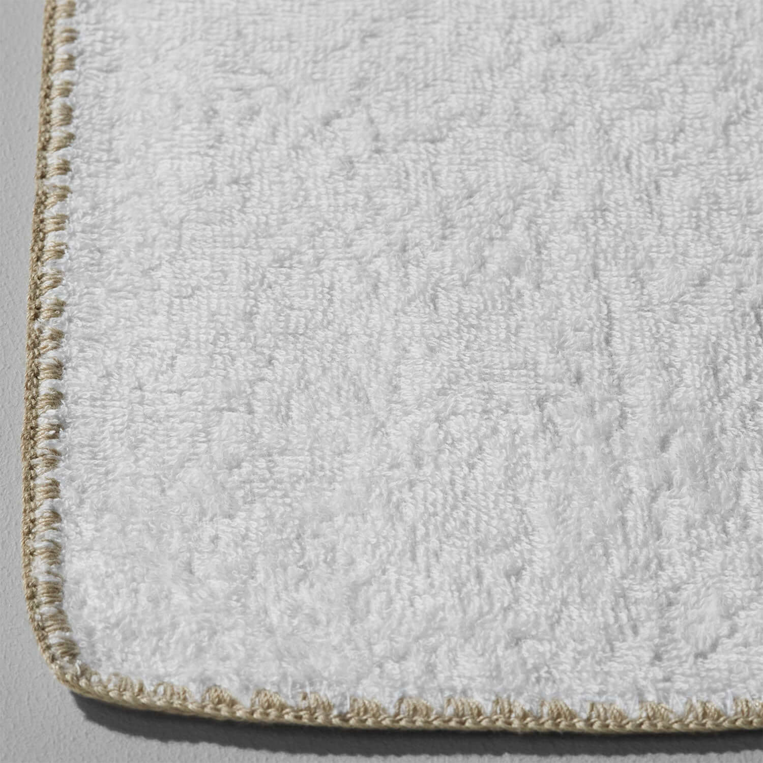 Bordado Towel with sand trim, thinly plush, space-saving design, water and energy efficient.