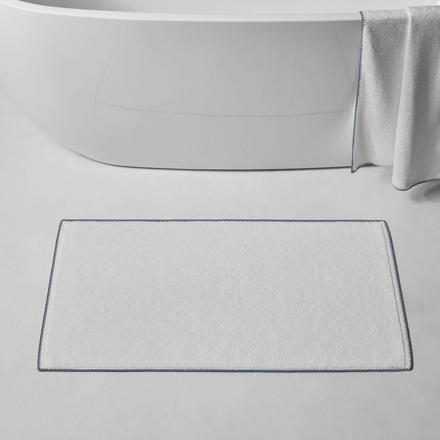 Bordado Mat with gray trim, featuring Slip-Less technology, perfect for bathrooms or bedrooms.