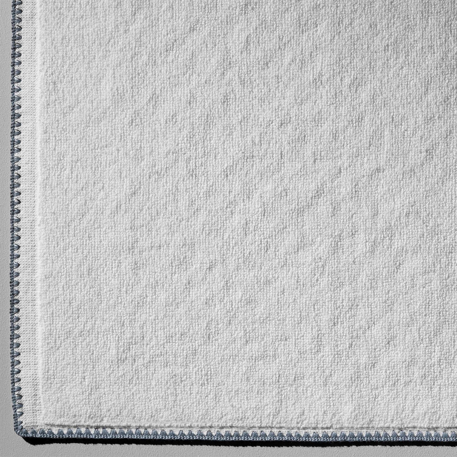 Bordado Mat with gray trim featuring eco-friendly materials and Slip-Less technology for bathroom and bedside use.
