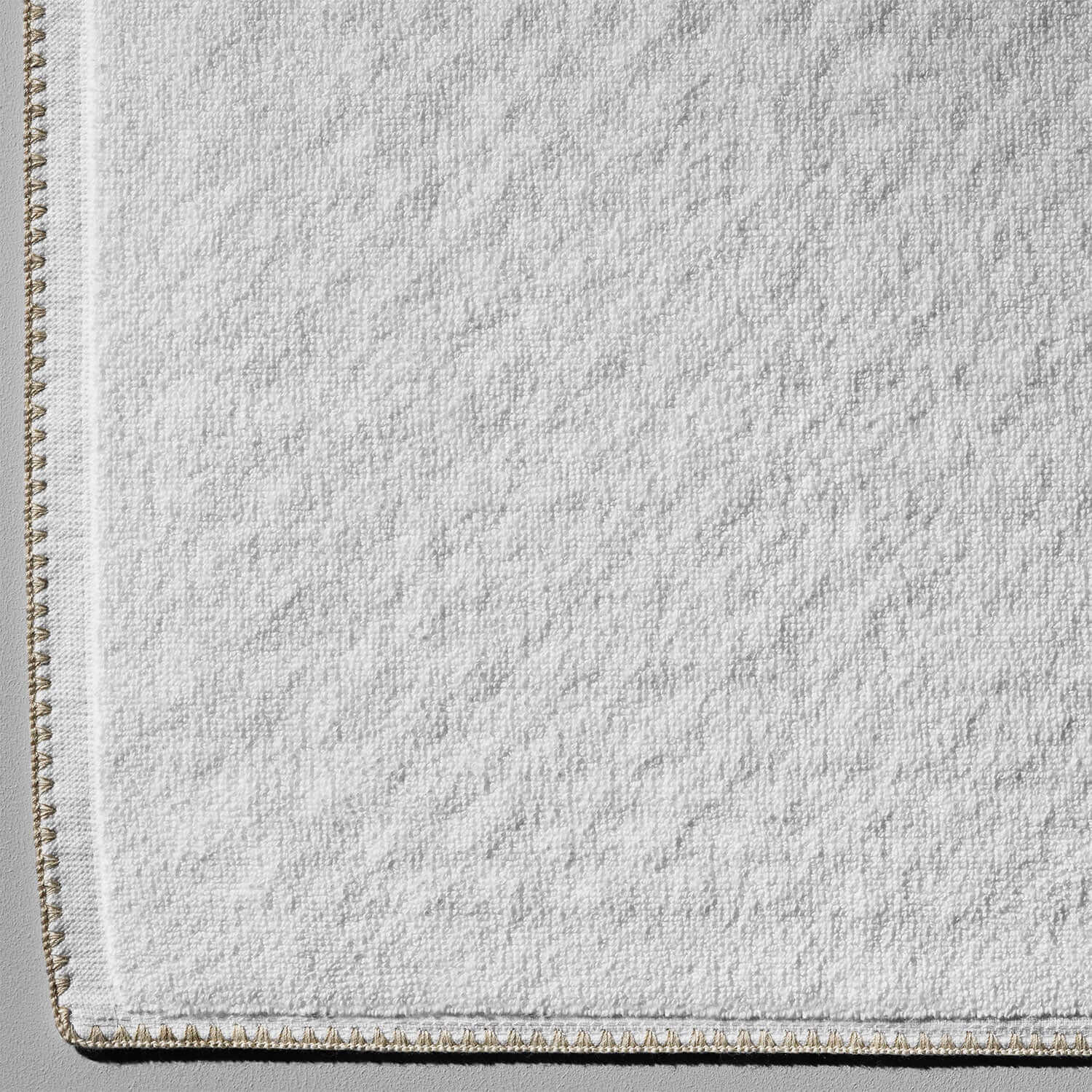 Bordado Mat Sand Trim in soft white with eco-friendly cotton and millennial grey trim, perfect for elegant bathrooms.