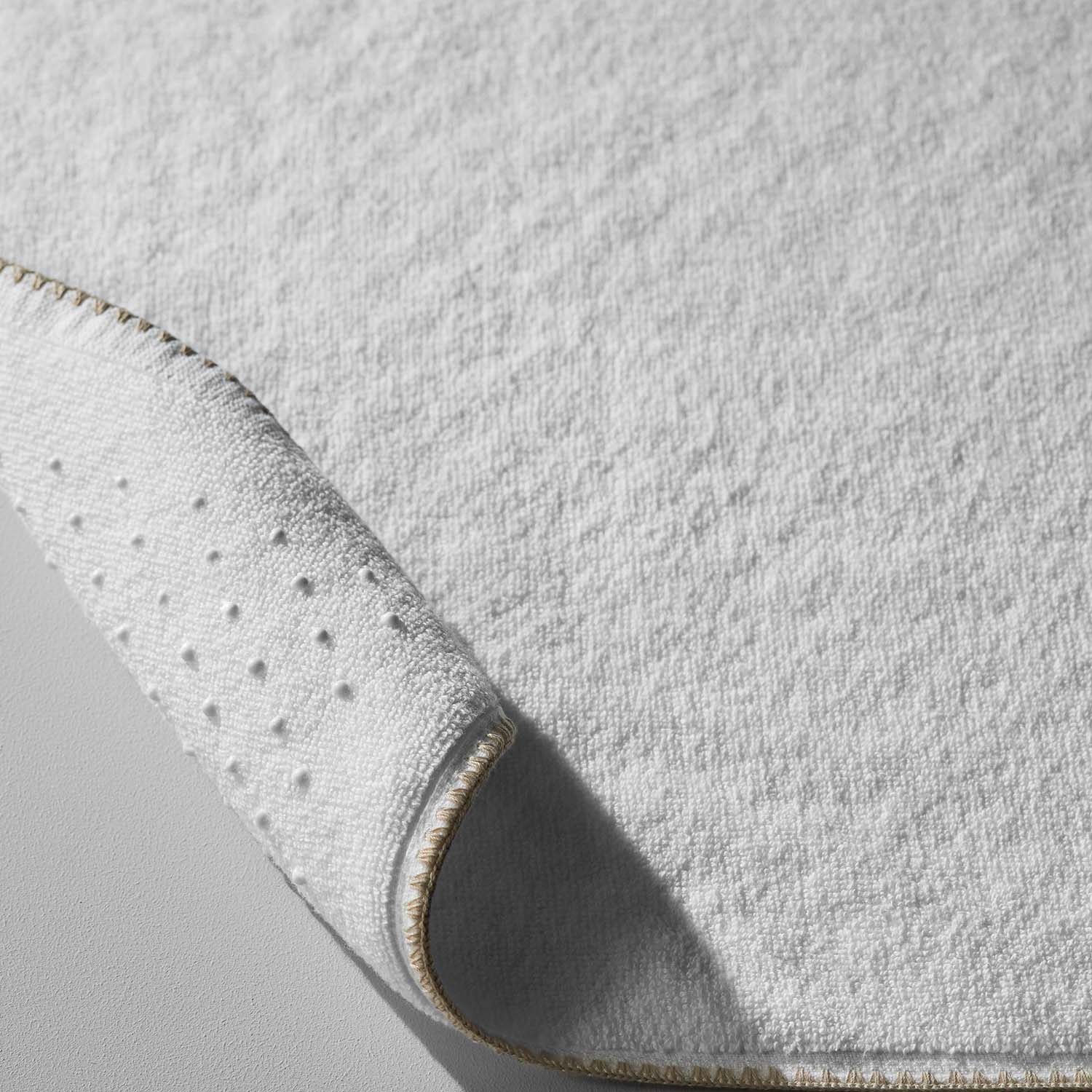 Close-up of Bordado Mat with eco-pellets for grip and millennial grey cotton trim for stylish comfort.