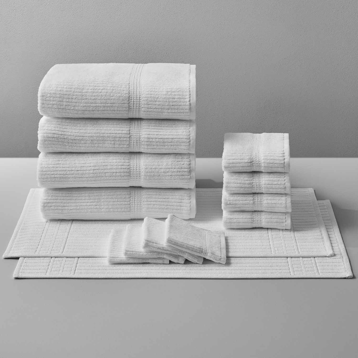 Canelado towel set displayed for daily spa rituals at home, featuring various sizes of soft, textured towels.