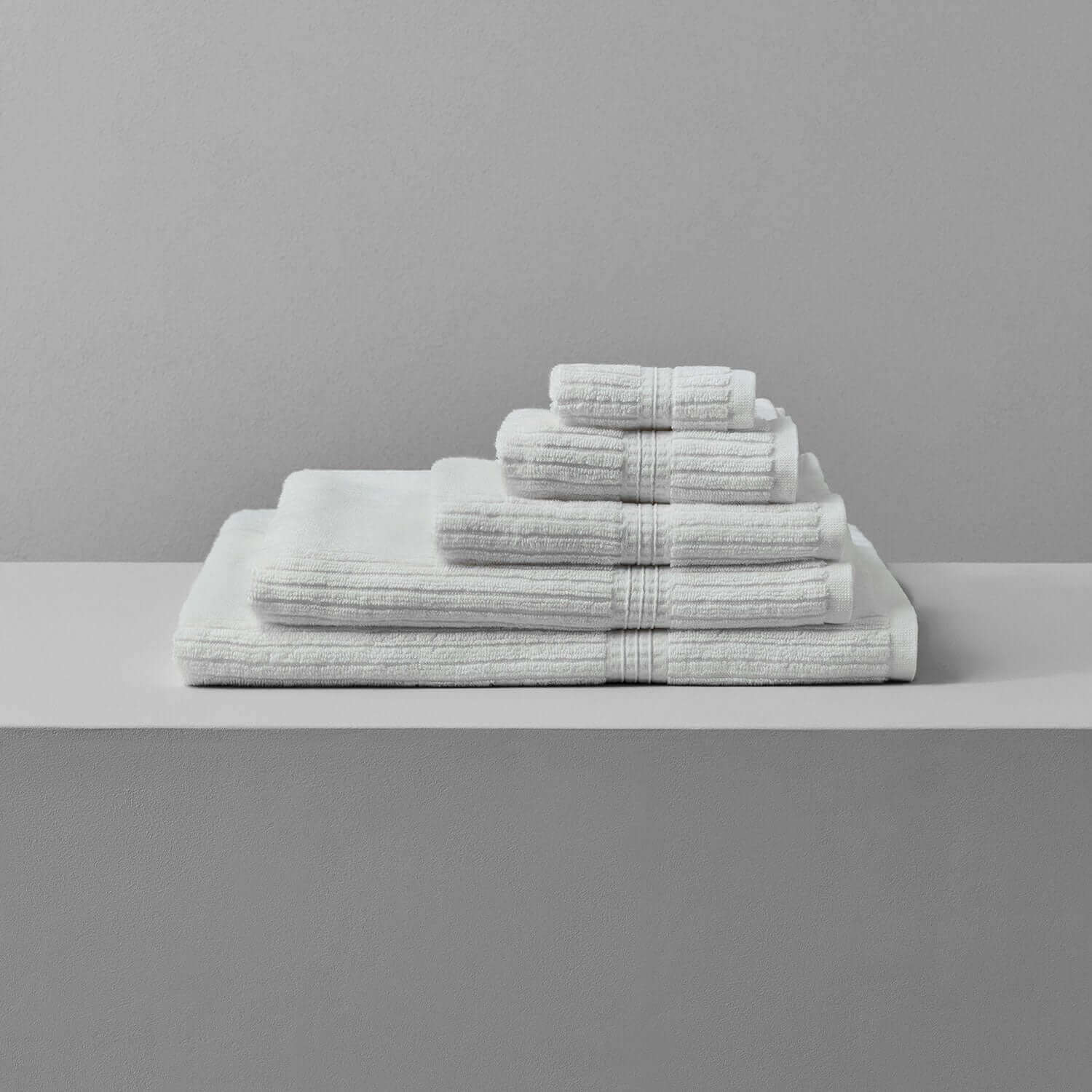 Canelado Towel set displayed on a shelf, perfect for daily spa rituals at home.
