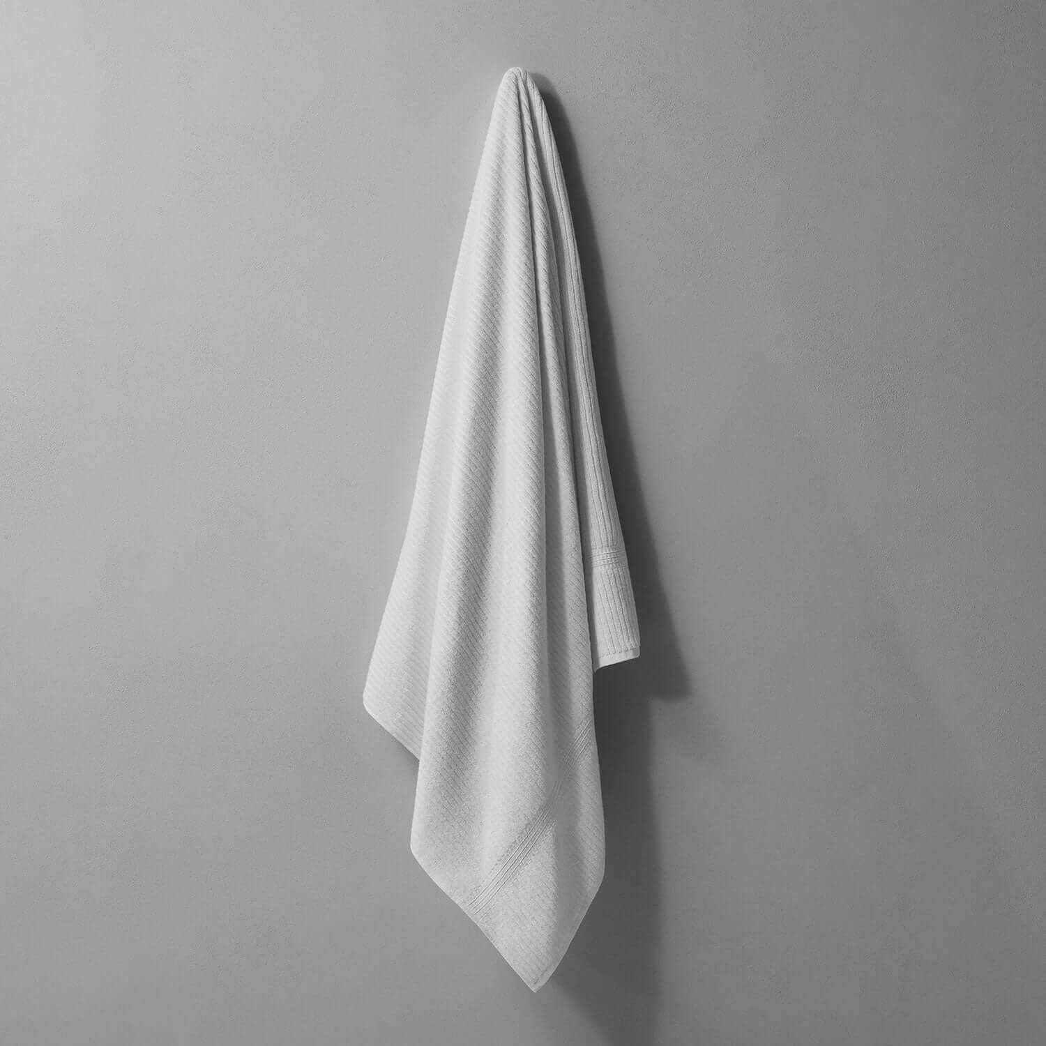 Canelado towel hanging on a wall, perfect for daily spa rituals at home, offering luxury and comfort.
