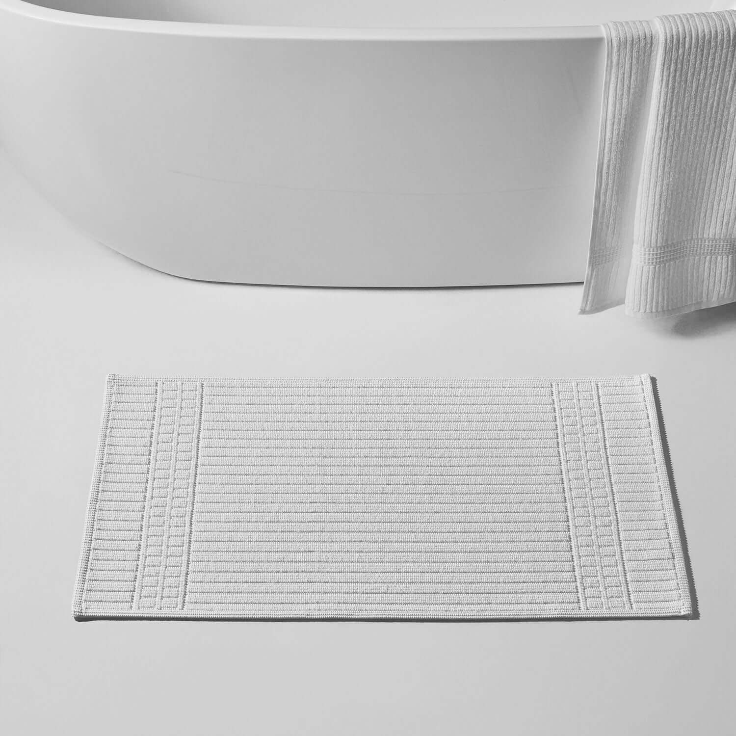 Canelado Mat in white, showcasing textured design, ideal for hotels and spas, enhancing bathroom elegance.
