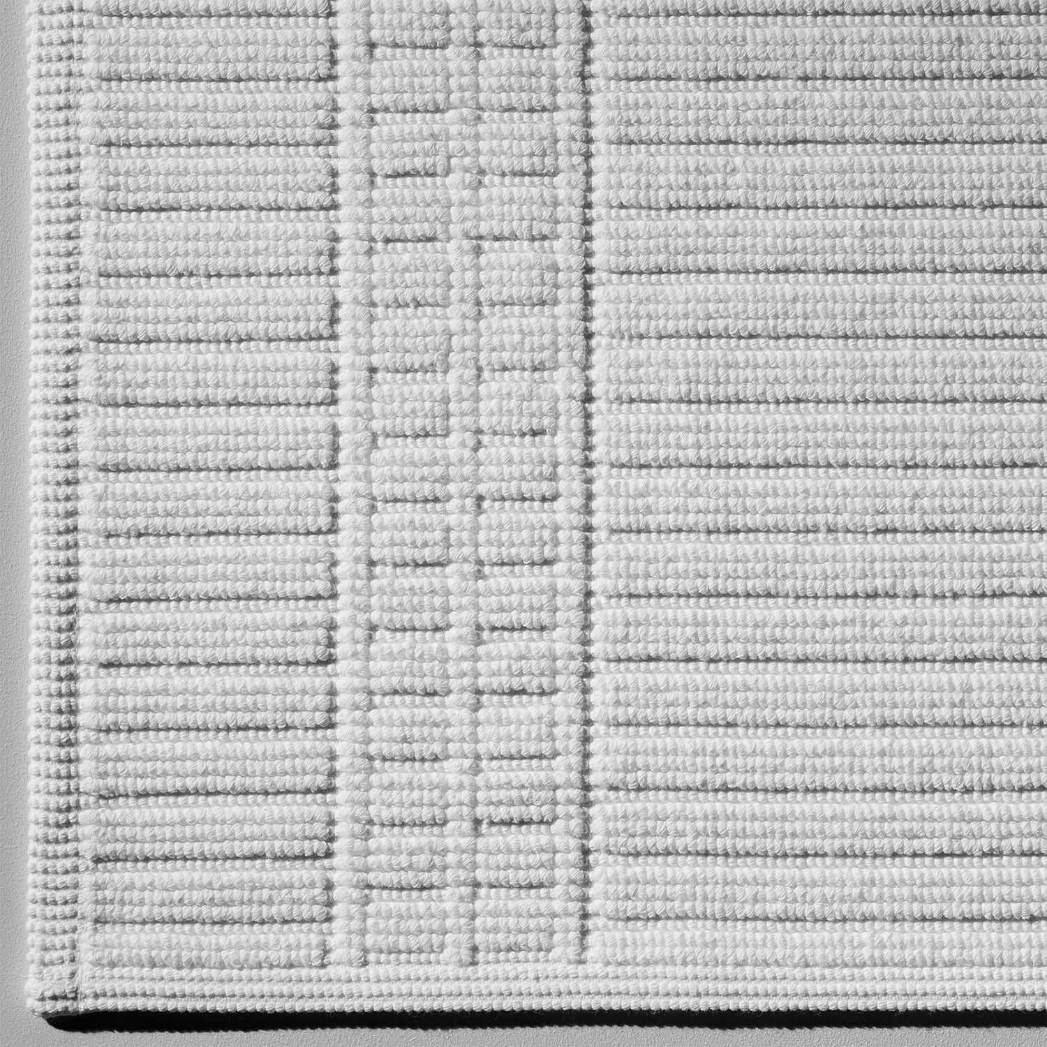 Canelado bath mat showcasing luxurious texture and pattern, crafted from sustainable long-fibre Brazilian cotton.