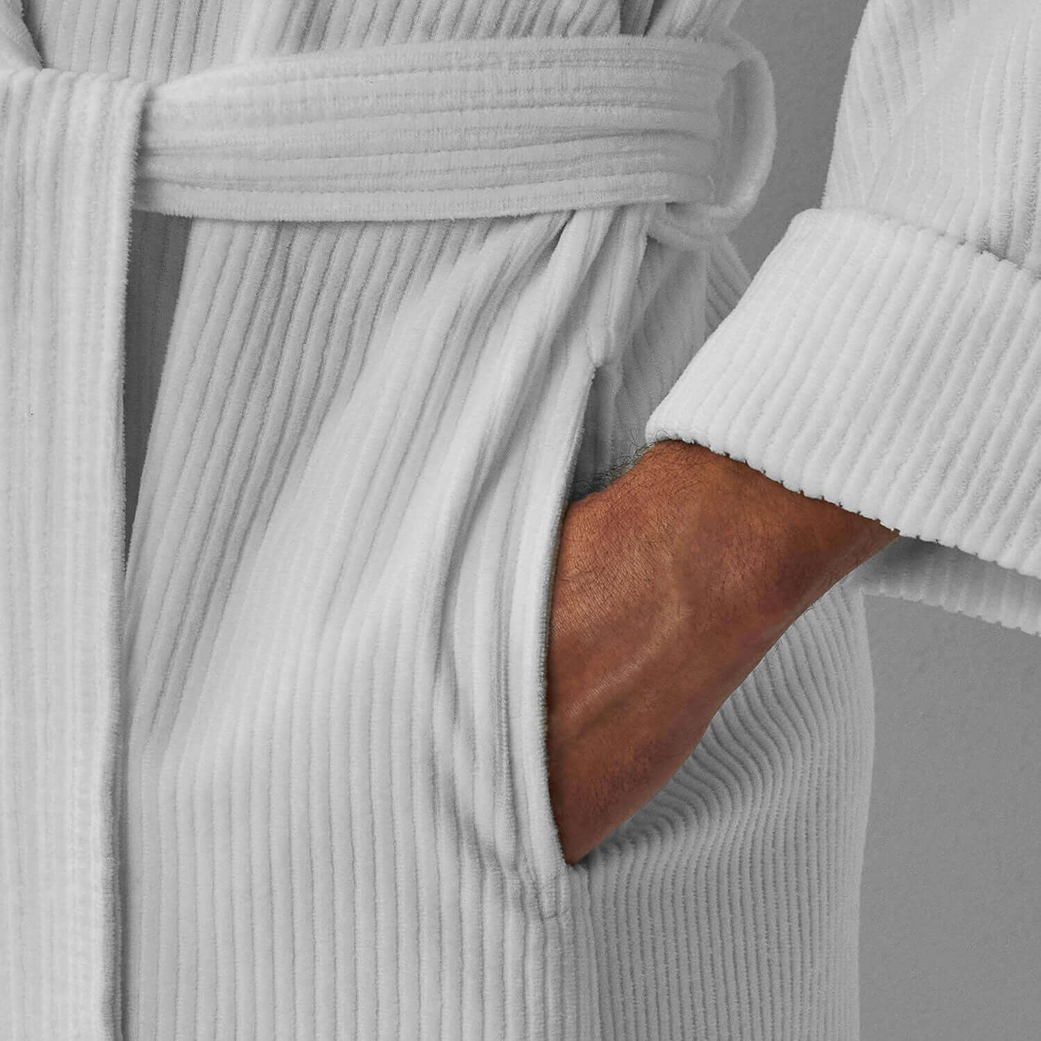 Close-up of a white luxuriously soft shawl robe with a pocket, perfect for at-home spa rituals.
