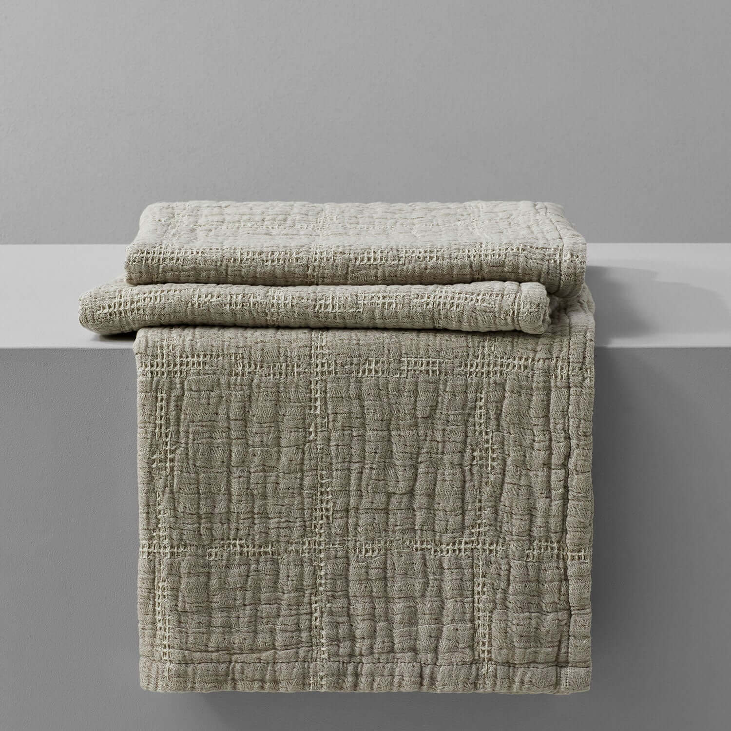 Lightweight stone-beige stitched blanket showcasing soft texture and rustic charm, perfect for home decor and luxurious comfort.