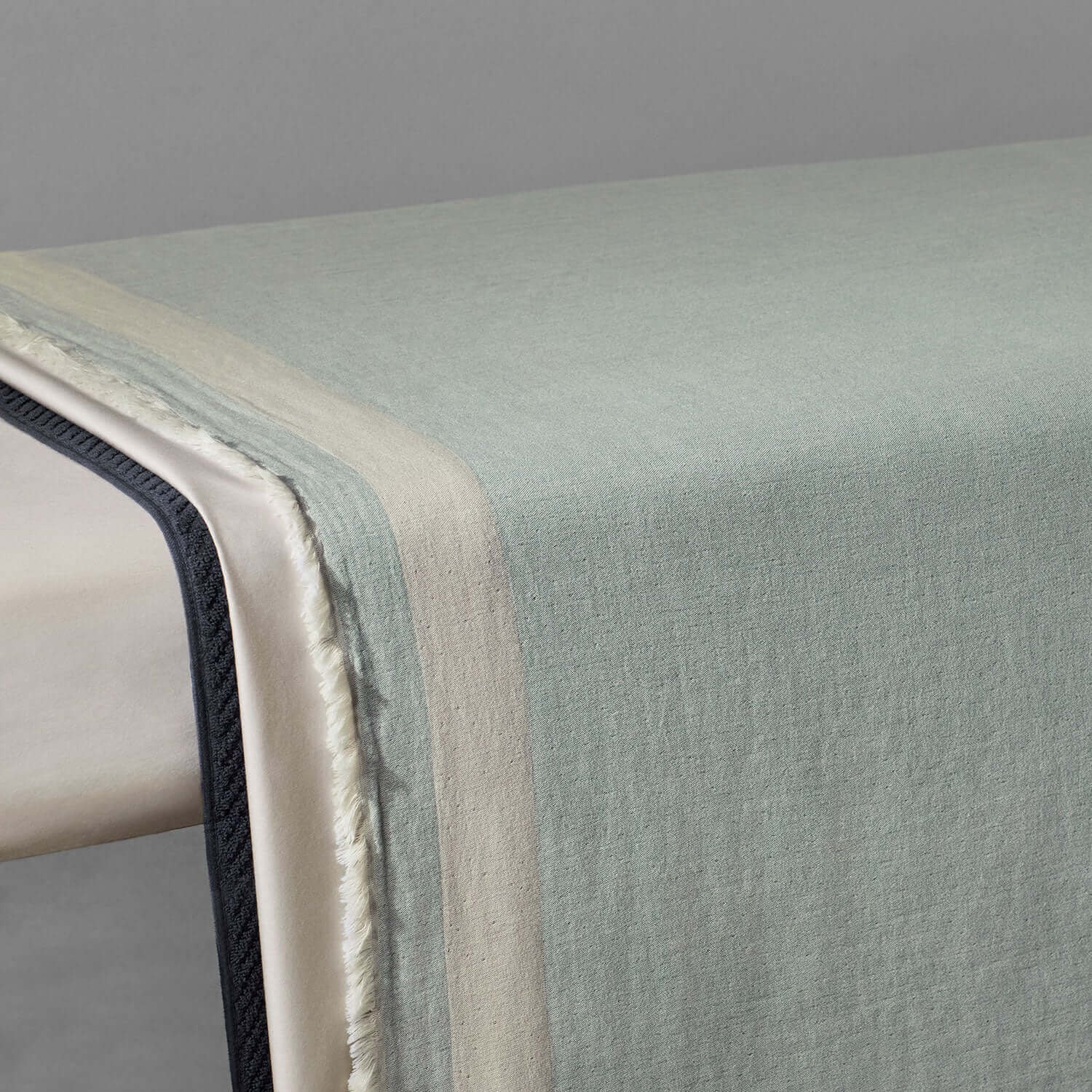 Elegant two-toned, eco-friendly Cenote blanket showcasing three layers of soft fabric for hotels and spas.
