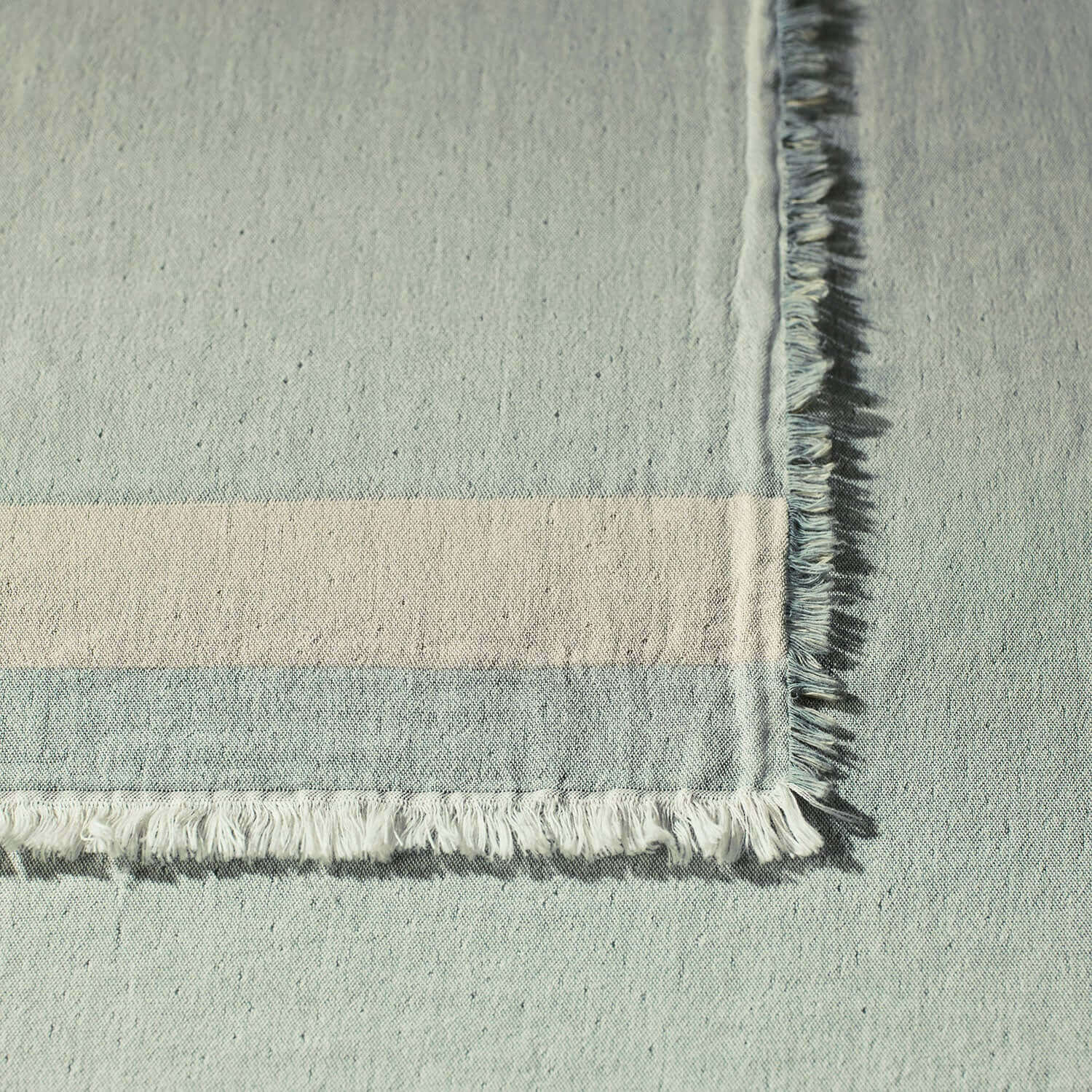 Close-up of the two-toned Cenote Blanket showcasing its layered texture and fringed edges for a cozy, chic look.