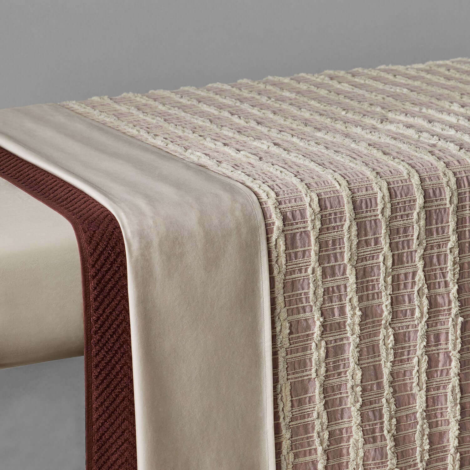 Lattice Blanket in light rose and salmon hues, showcasing intricate criss-cross patterns and fringes for cozy decor.