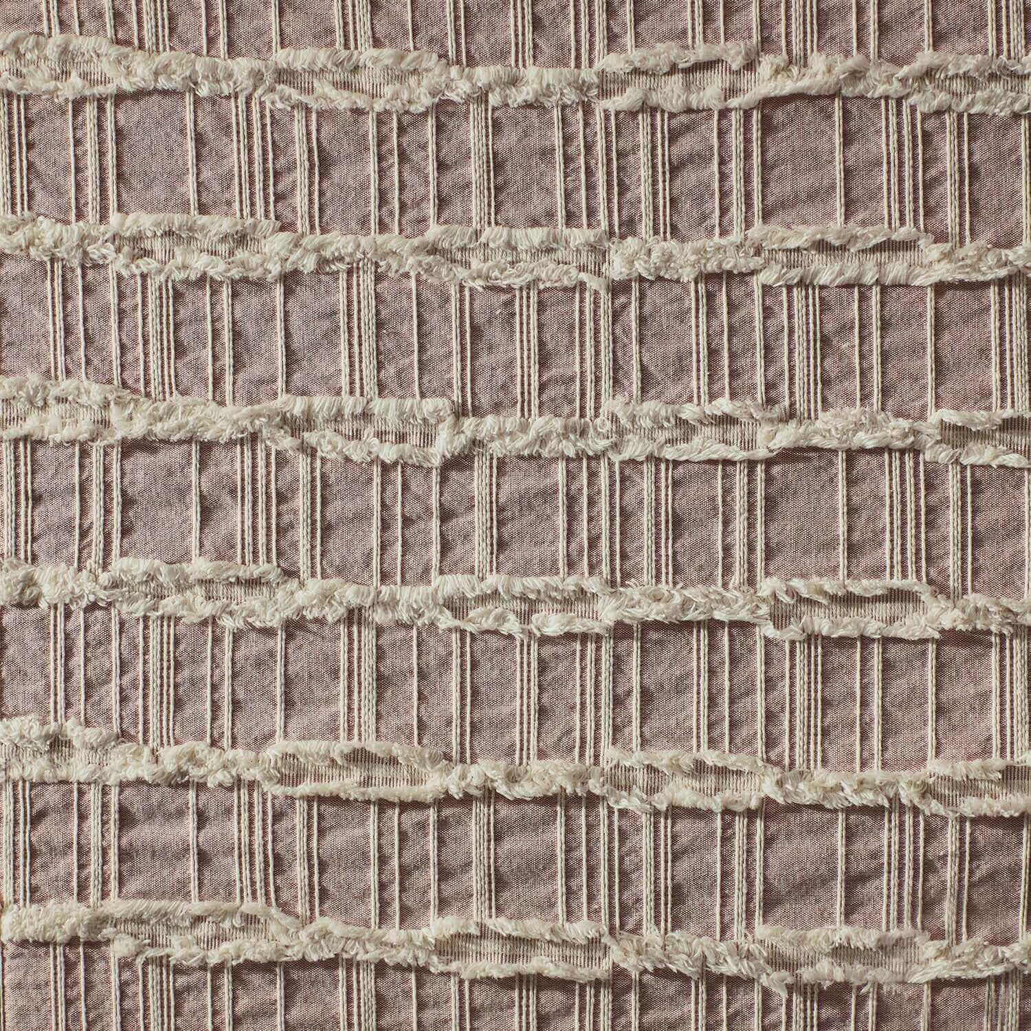 Lattice blanket featuring interlaced fringes in light rose and salmon colors, perfect for eco-chic hotels and resorts.