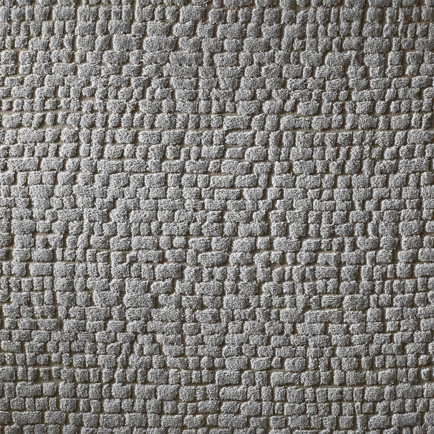 Gray pebble blanket texture showcasing durable cotton terry construction for spa rooms.