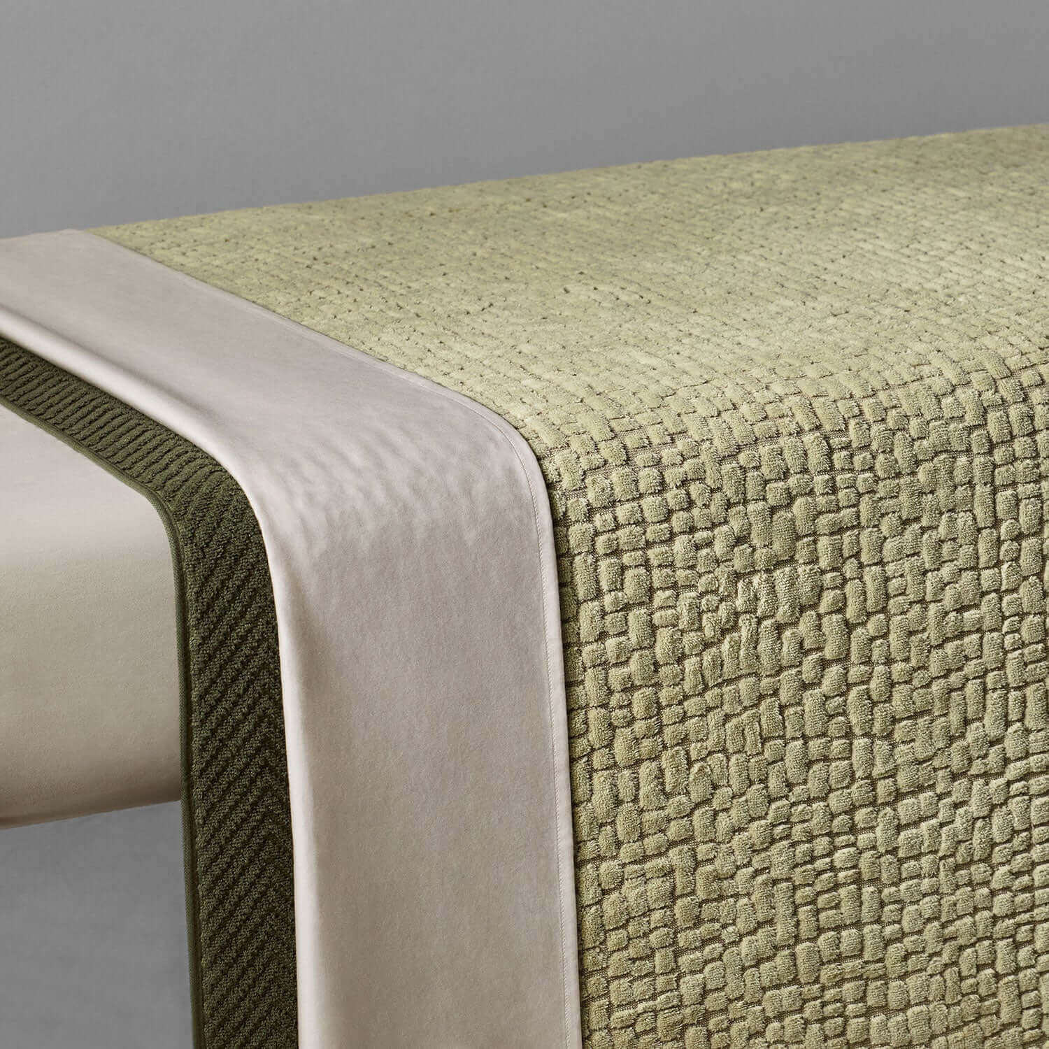 Pebble blanket in sage green, showcasing natural softness and durability for spa settings, made from sustainable cotton.