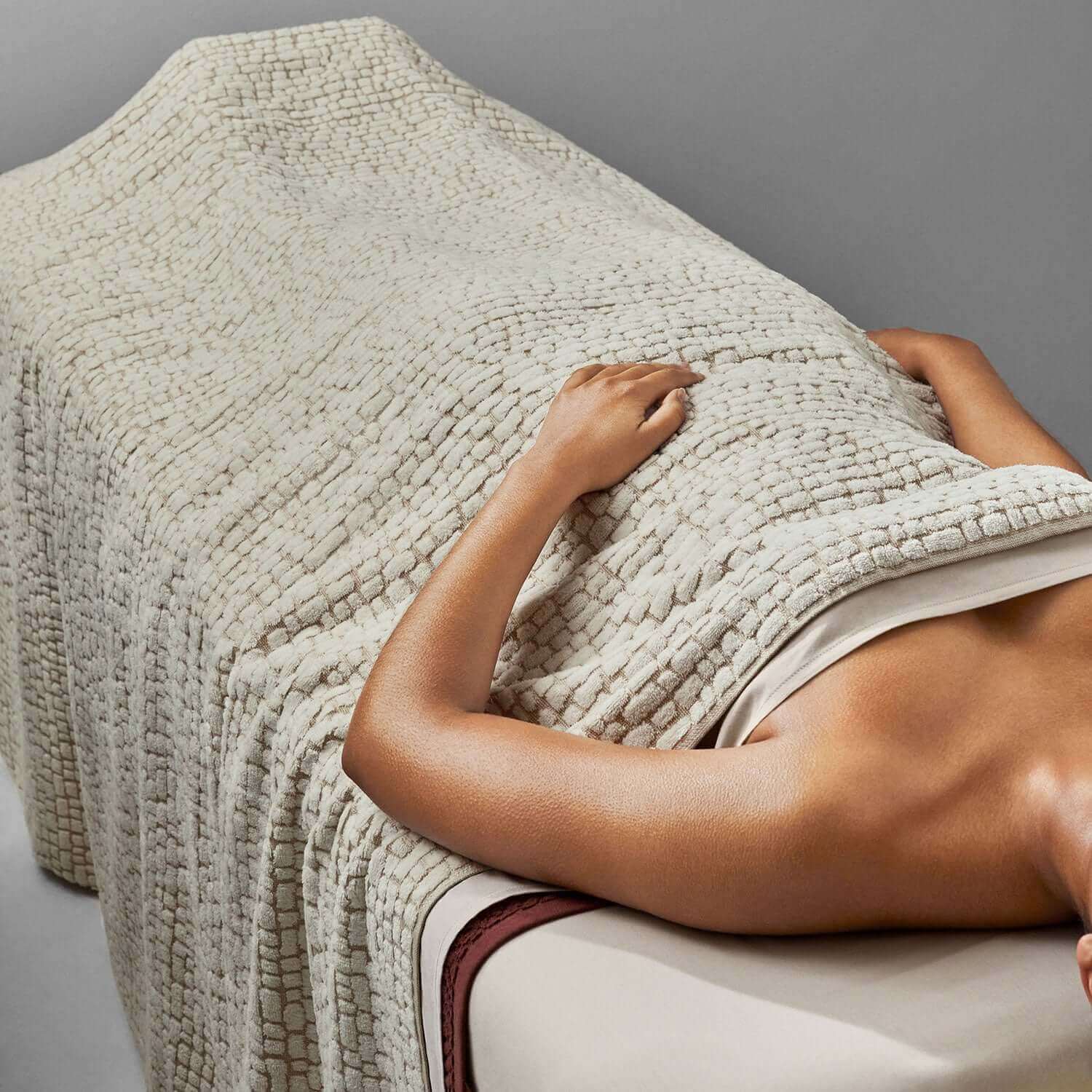 Pebble blanket in a spa setting, showcasing natural texture and softness for enhanced relaxation.