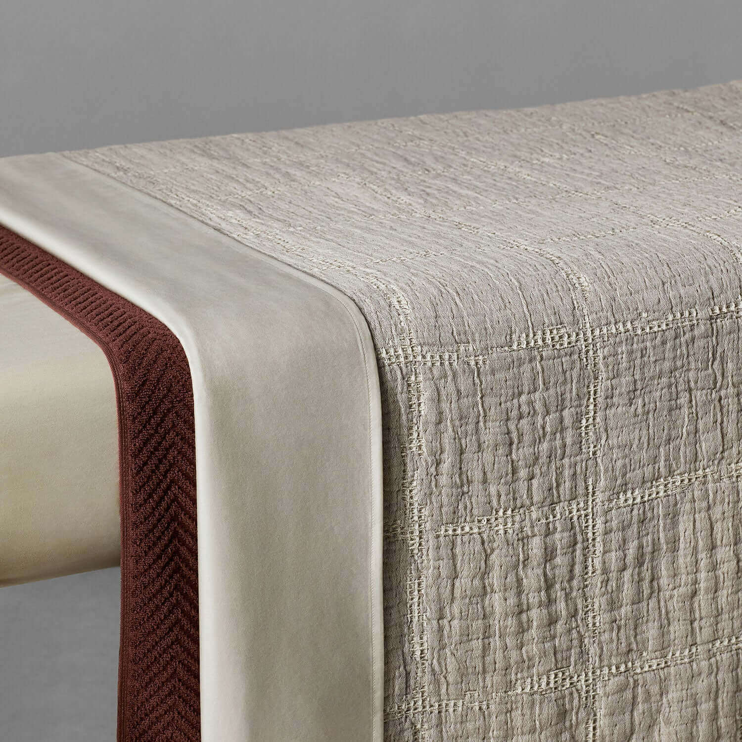 Textured stone-beige stitch blanket showcasing natural elegance and rustic charm, perfect for modern decor.