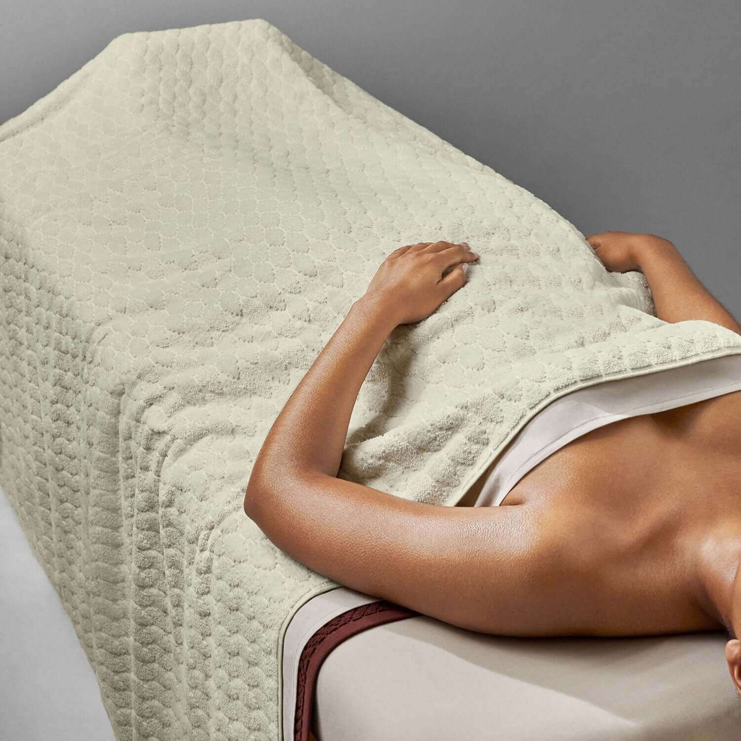 Velour blanket draped over a person receiving a massage, ideal for spa and relaxation settings.