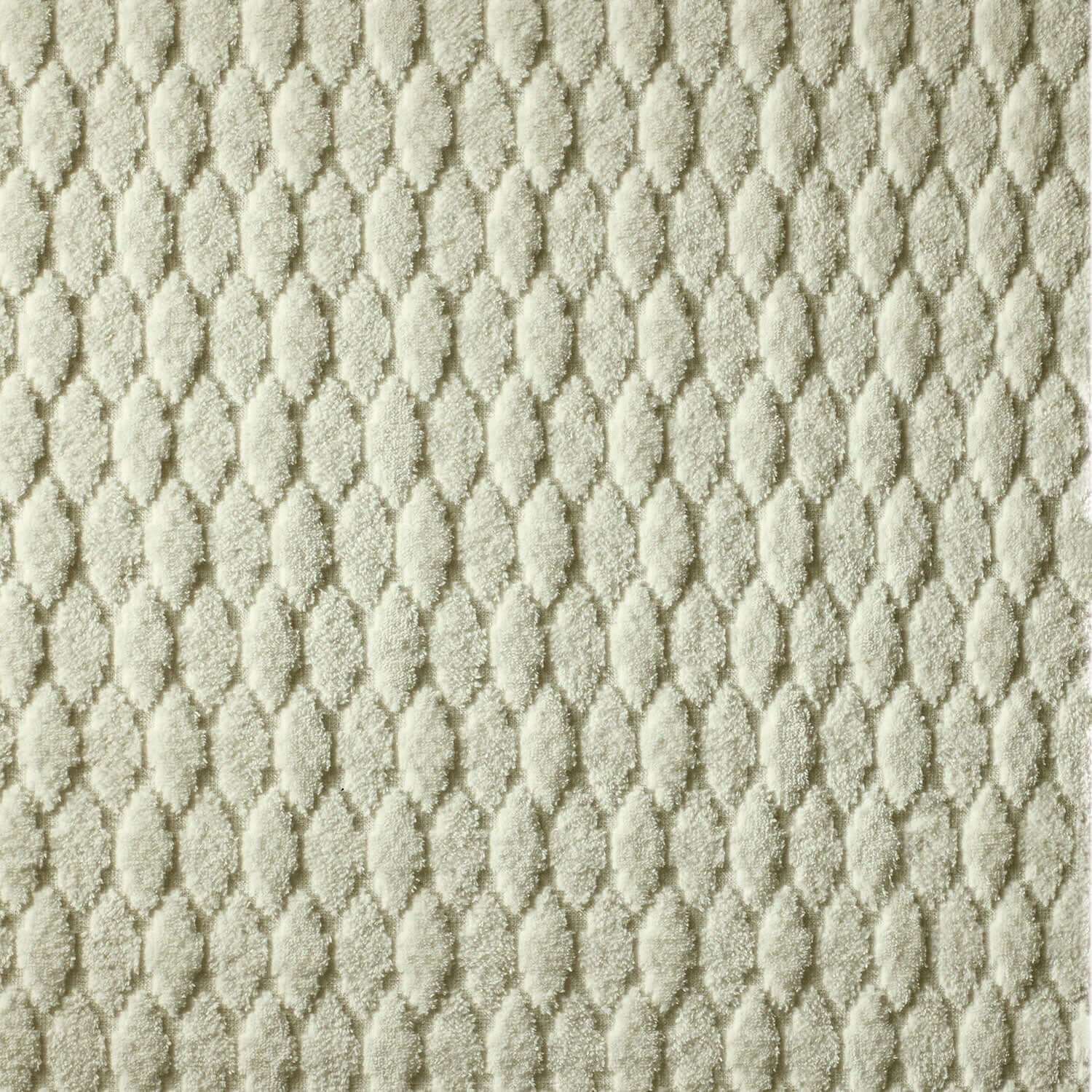 Close-up of a soft cotton terry jacquard velour blanket in a sophisticated pattern, ideal for decor and machine washable.