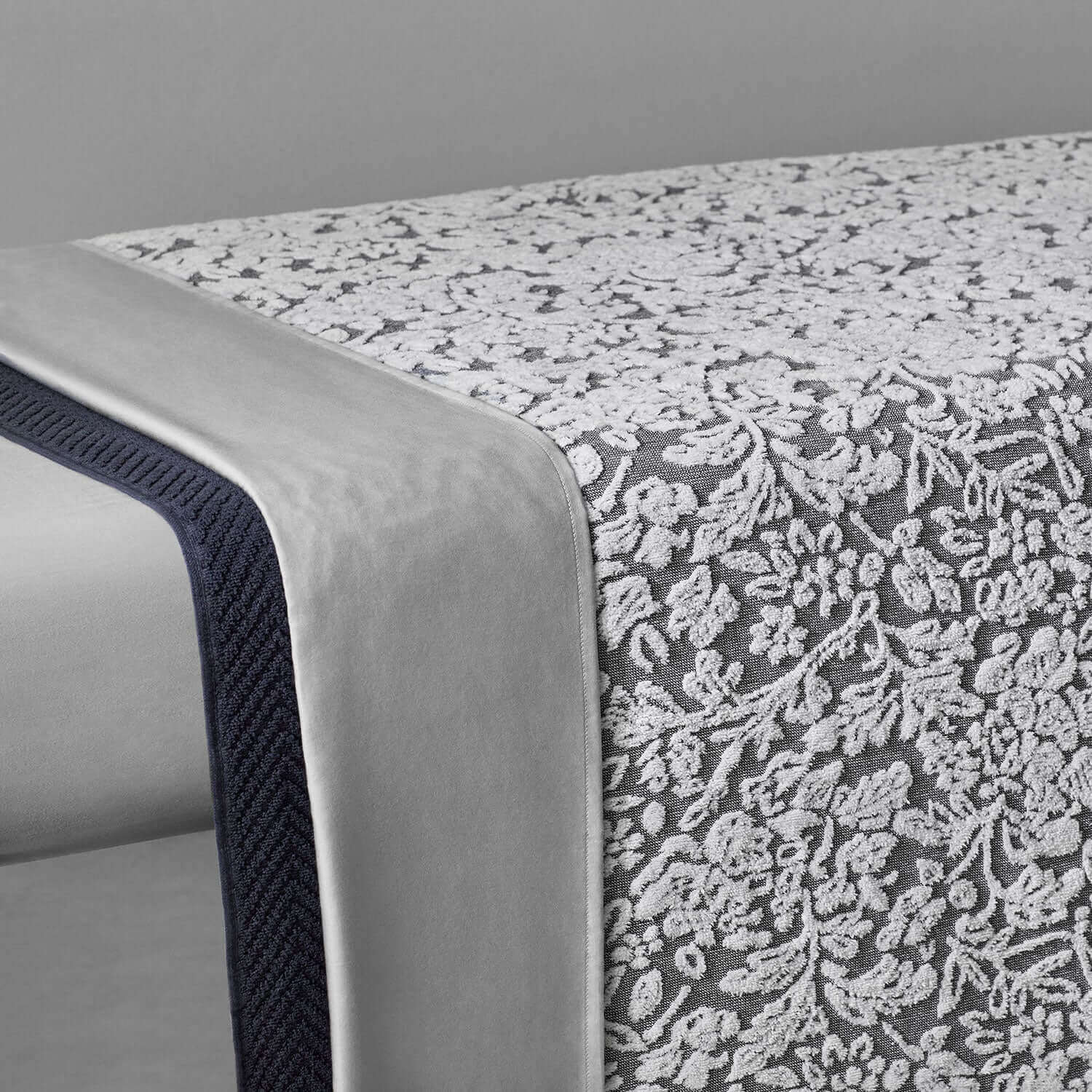 Elegant two-toned grey and white yarn-dyed cotton blanket showcasing intricate jacquard weave details.