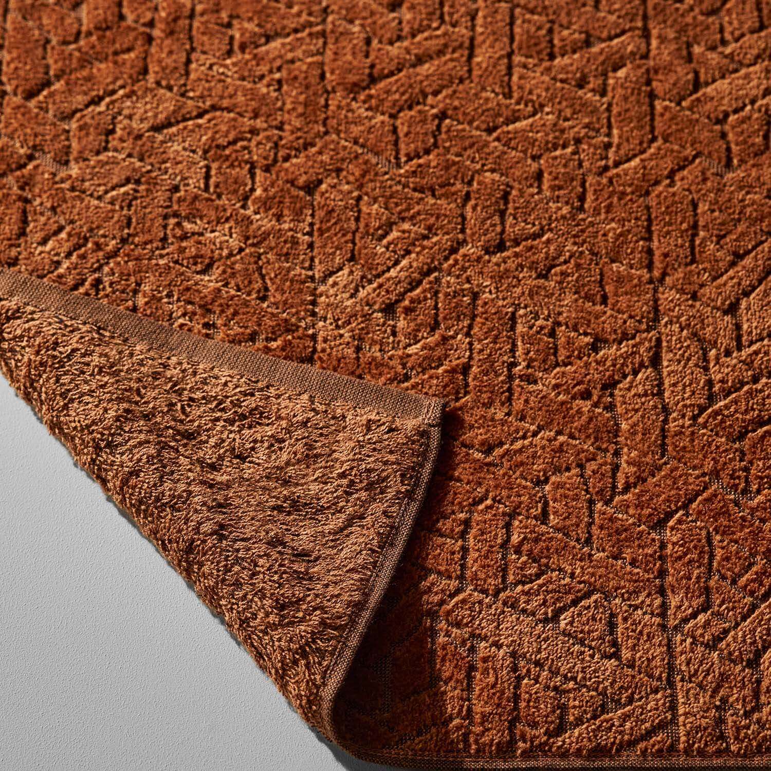 Wabi Sabi blanket in warm tones, showcasing minimalist design and luxurious, sustainable craftsmanship.
