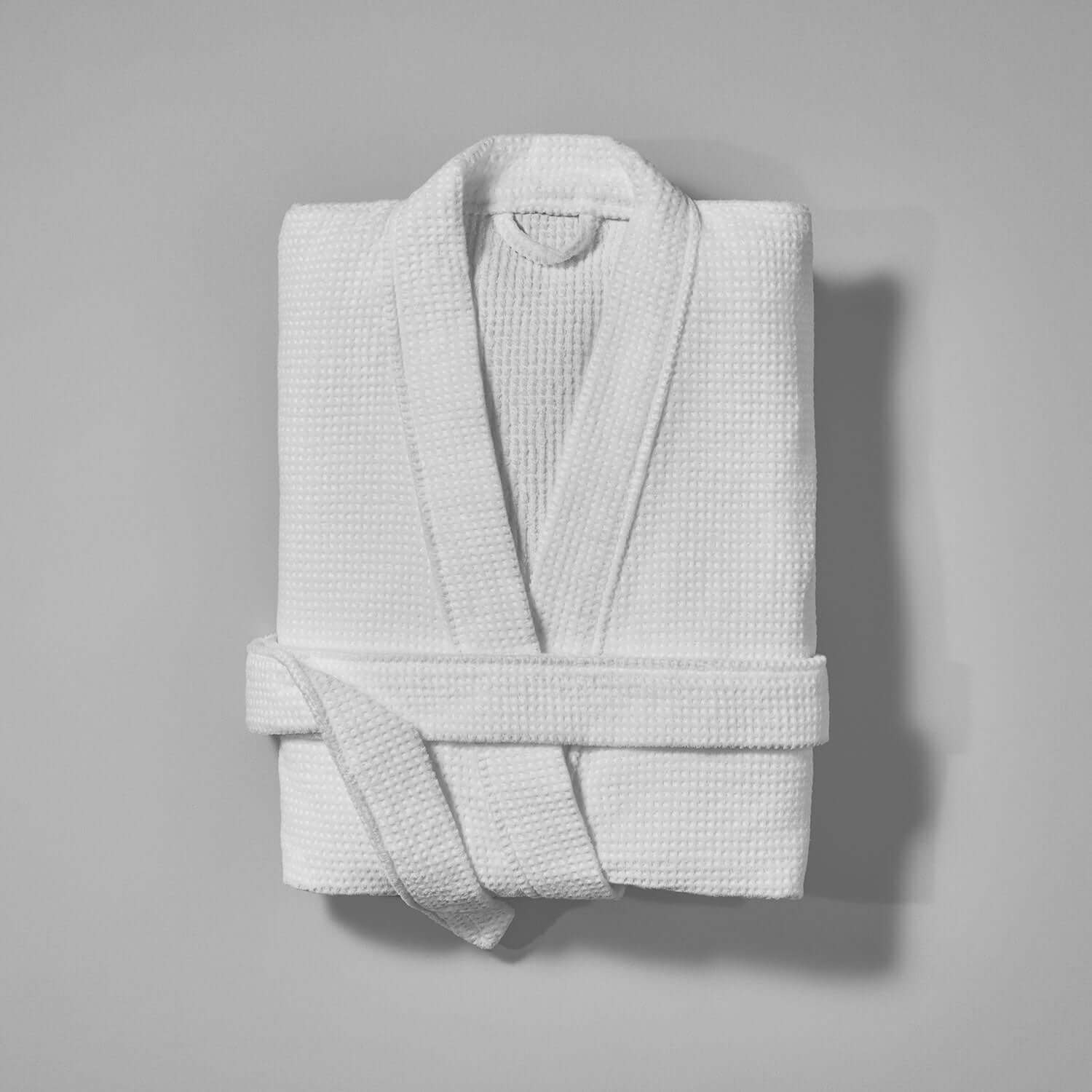Novotel Kimono in soft white fabric, featuring a textured pattern and a belted design for luxurious comfort.