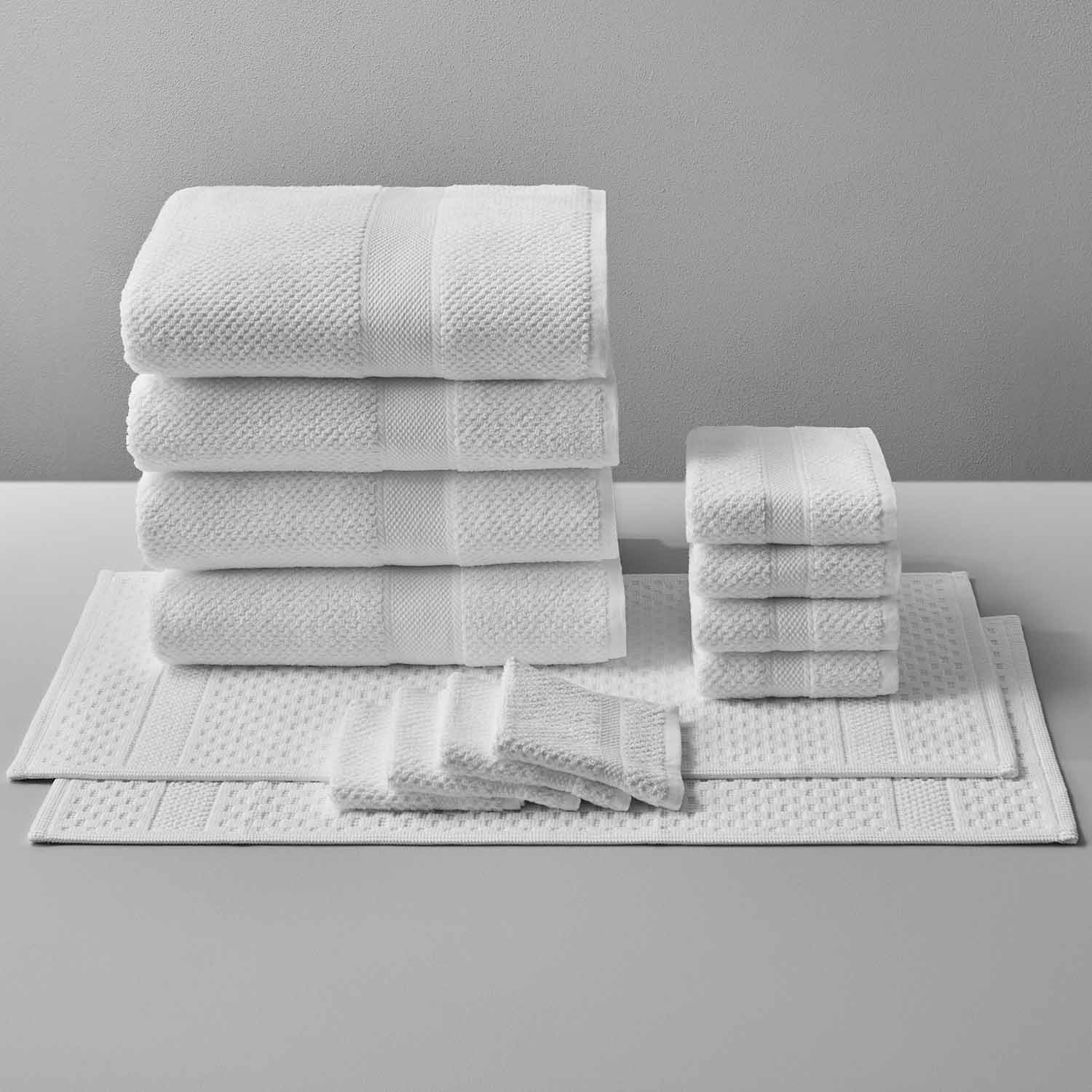 Luxury Novotel towels stacked neatly, showcasing premium 100% Brazilian cotton for sports, clubs, and yoga.