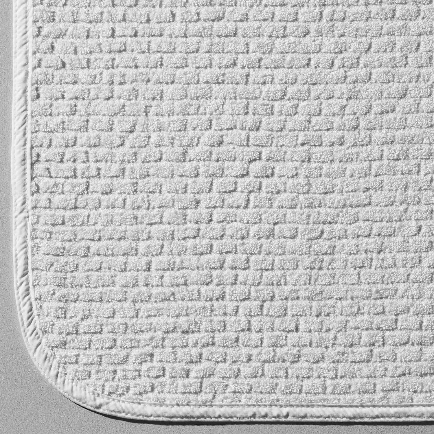 Textured white lounge chair cover made of 100% cotton, featuring a non-slip design for comfort and aesthetic appeal.