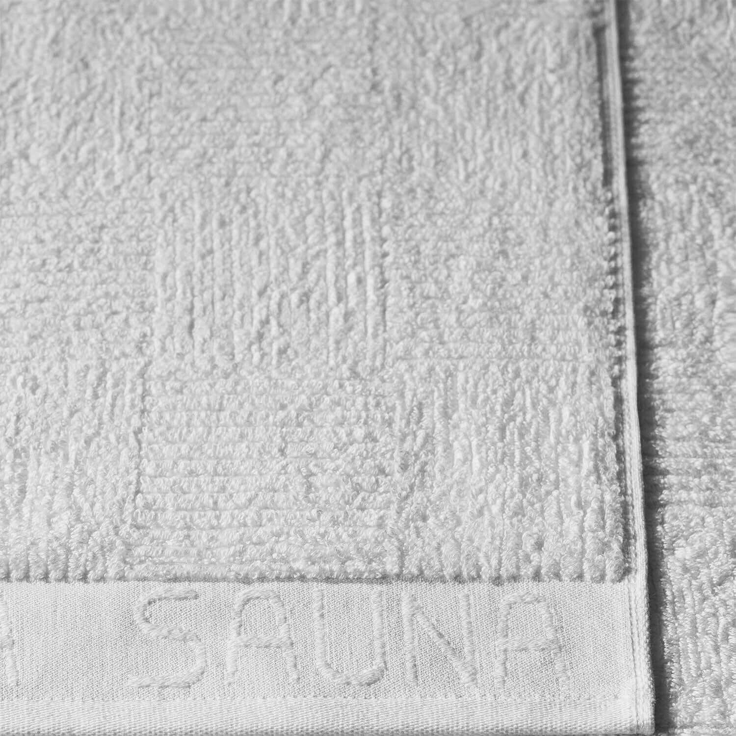 Luxurious white sauna towel, highly absorbent, perfect for sauna or steam room use, featuring a contemporary design.