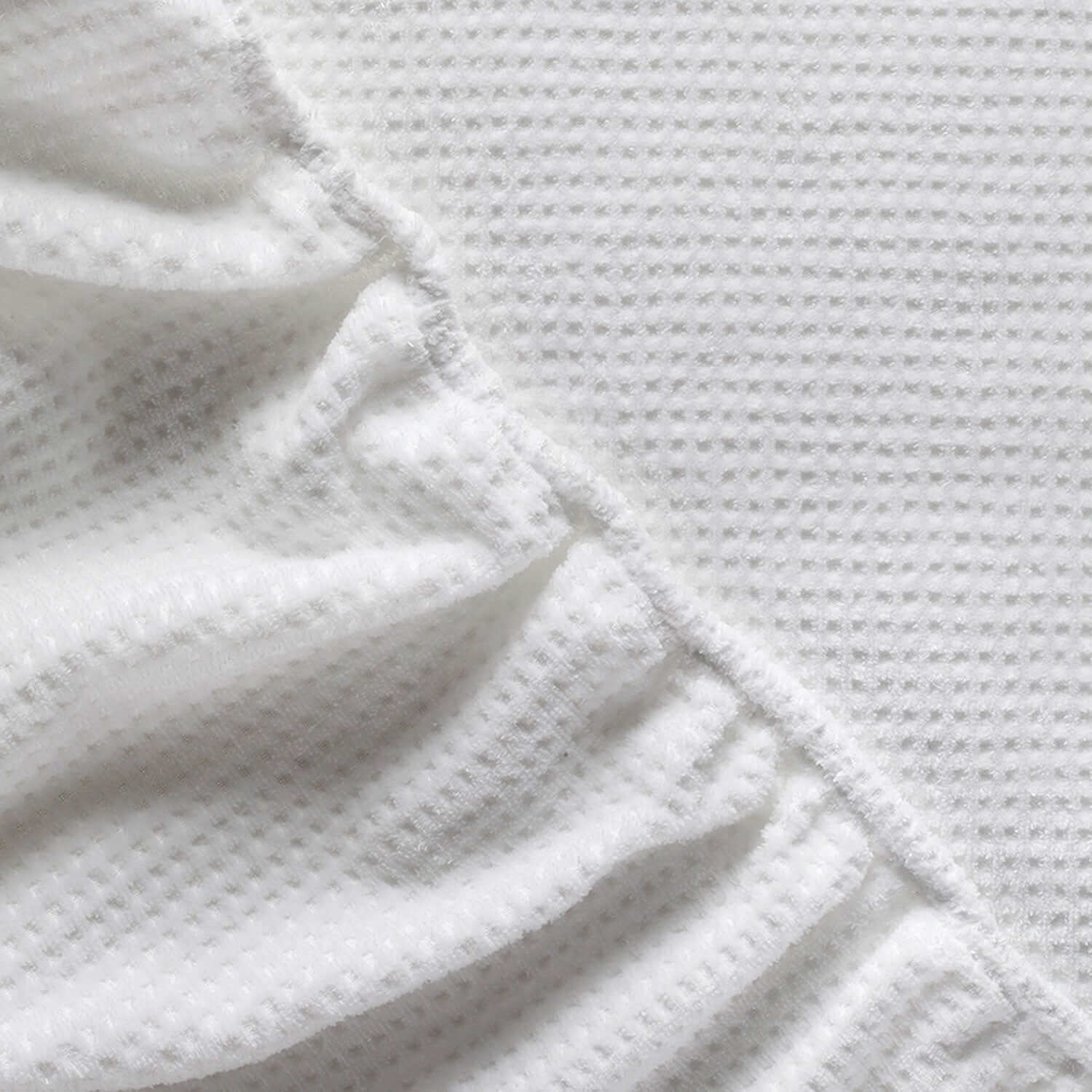 Close-up of supple, wrinkle-free velour fabric enhancing massage experience, perfect for spa and salon treatment linens.