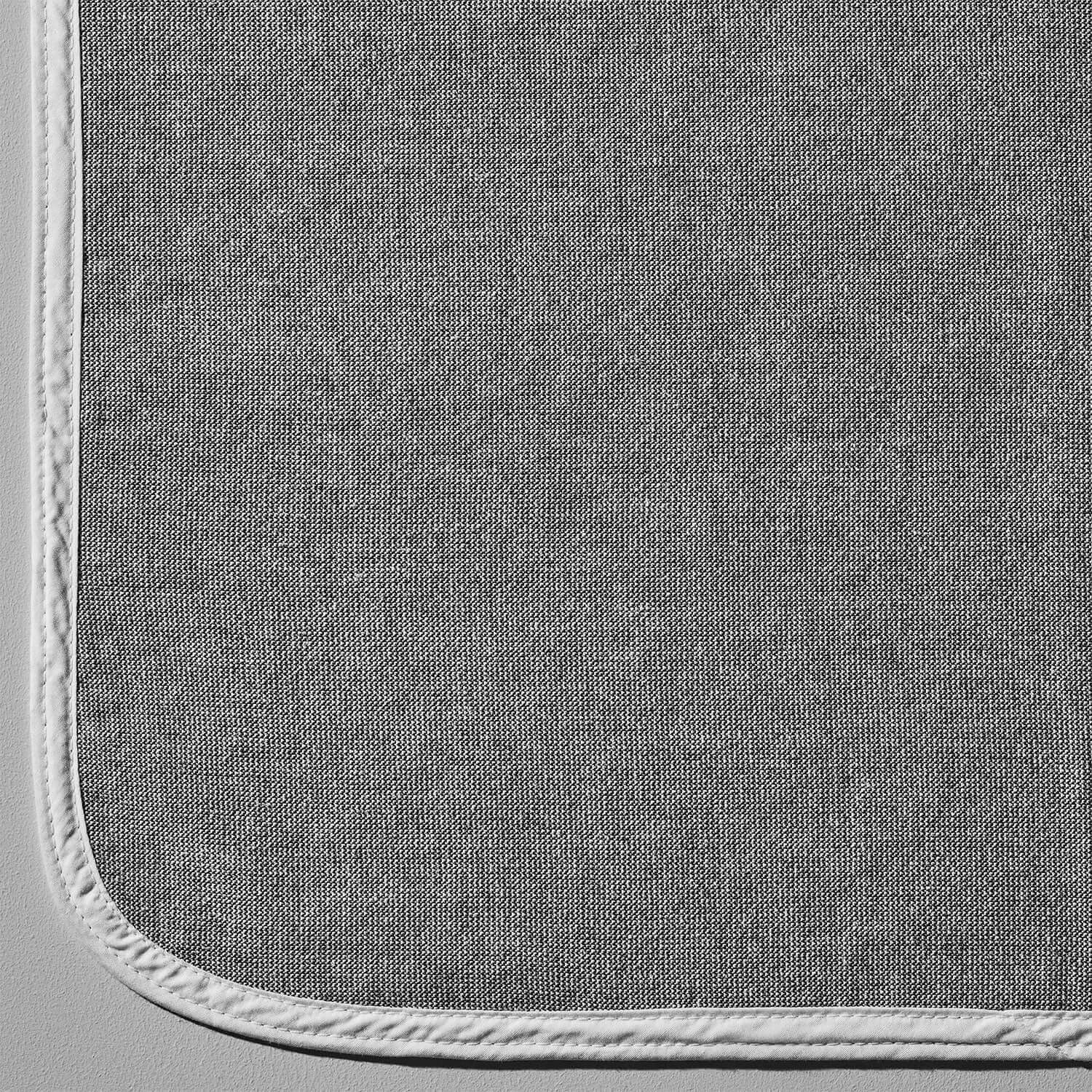 Close-up of SOL Lounge Chair Cover in gray with white trim, featuring a light-catching weave design.