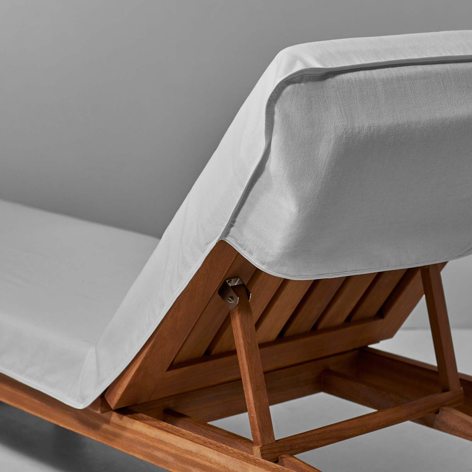 Close-up of a white SOL Lounge Chair Cover designed for comfort and style at luxury resorts and spas.