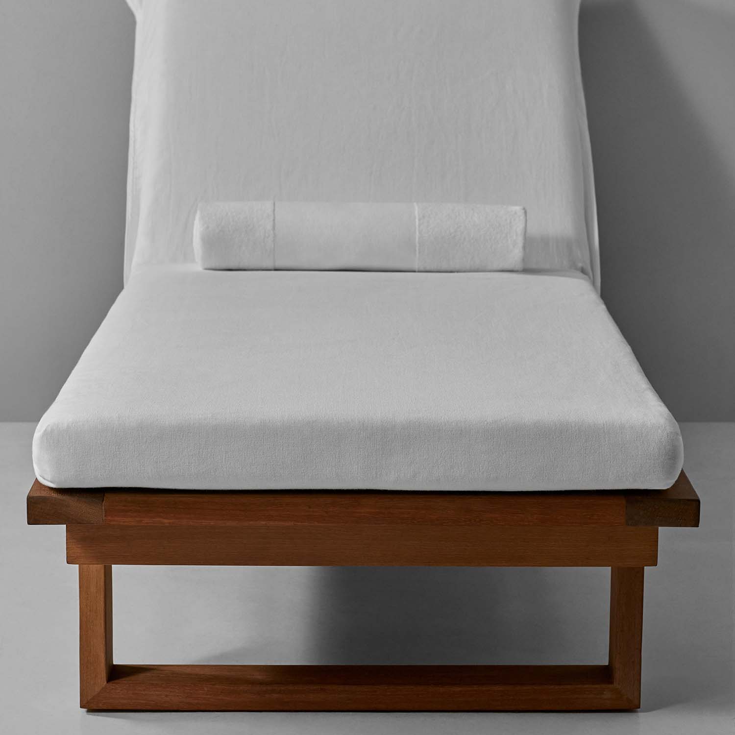 SOL Lounge Chair Cover in white on a wooden frame, designed for stylish comfort by the pool.