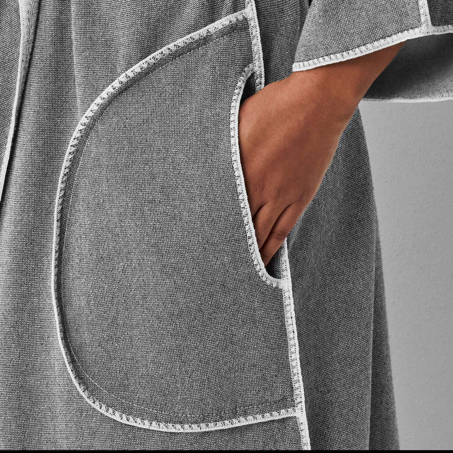 Close-up of gray SOL Robe showcasing pocket detail and soft terry fabric for a stylish and comfortable look.