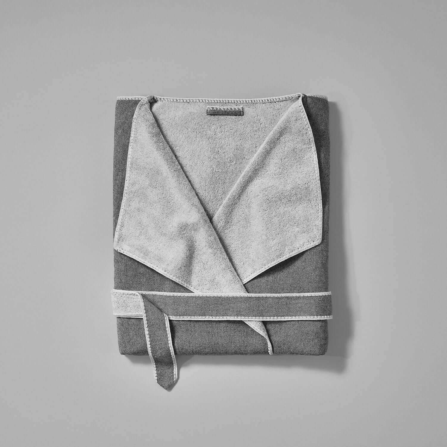 Folded gray SOL robe featuring a soft terry interior, cardigan-style lapel, and self-tie belt for ultimate comfort.