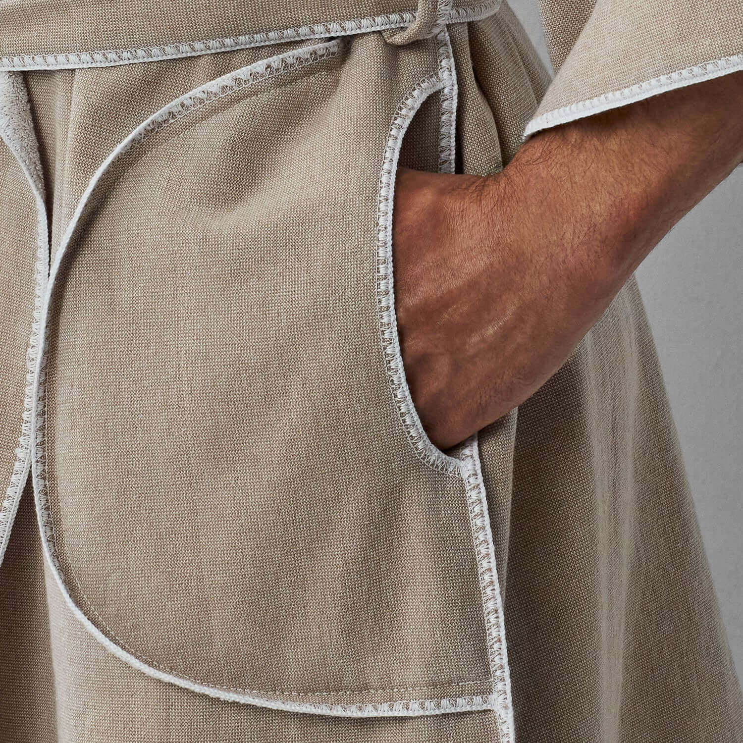 Close-up of SOL Robe Sand features, showcasing pockets and self-tie belt in eco-friendly design.
