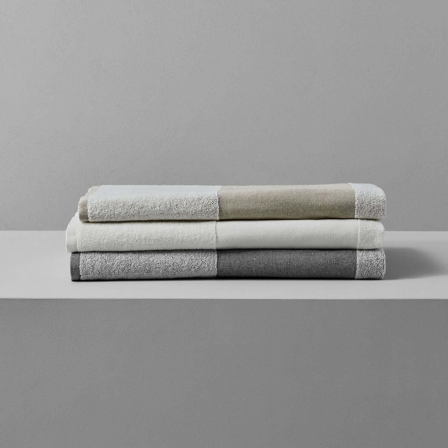 SOL Striped Towel White, Gray, and Green stacked, eco-friendly towels for beach, pool, and sports use.