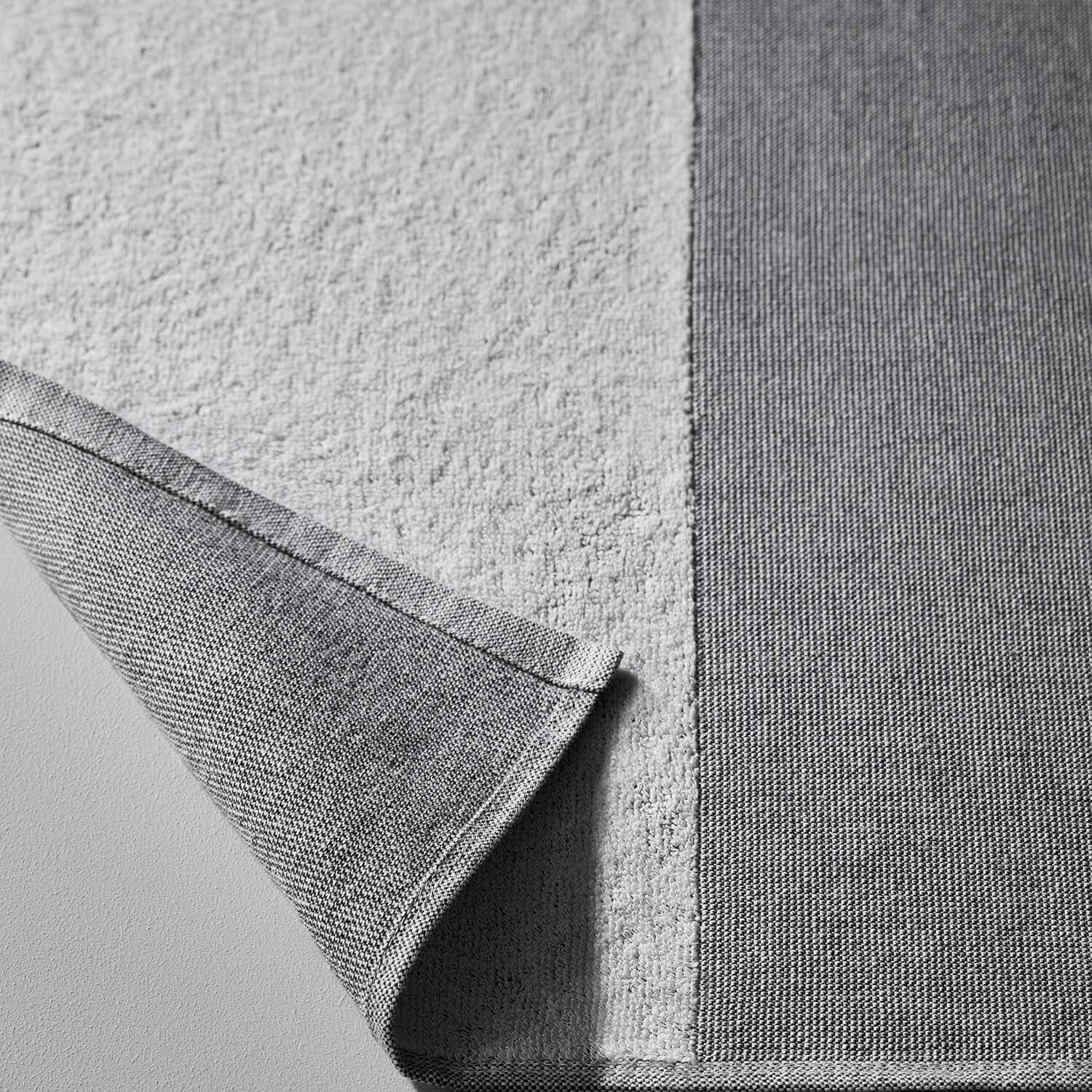 Close-up of SOL Striped Towel in gray, showcasing eco-friendly fabric ideal for beach, pool, and gym use.