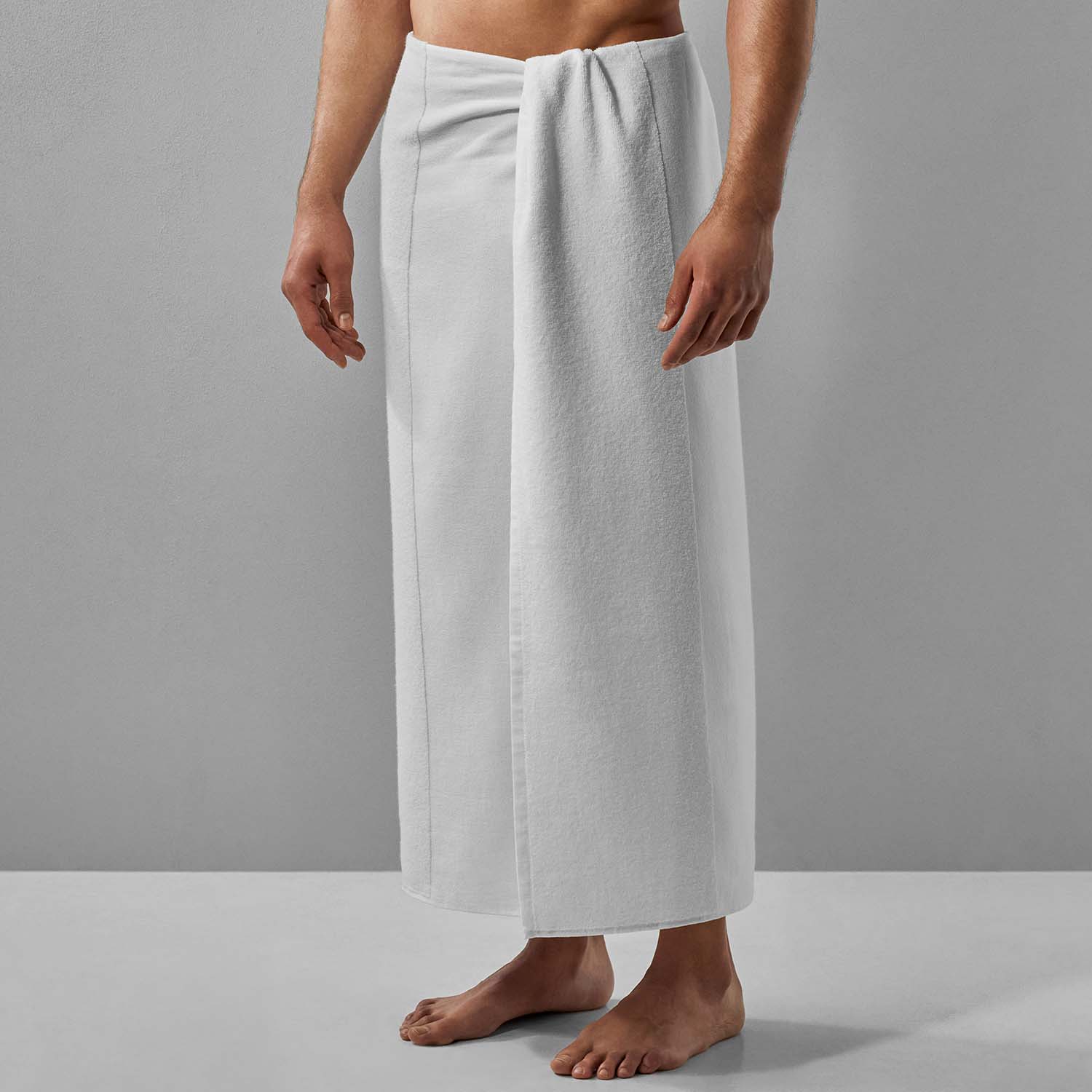 SOL Striped White Towel wrapped around a man, showcasing eco-friendly design for beach, pool, and sports use.