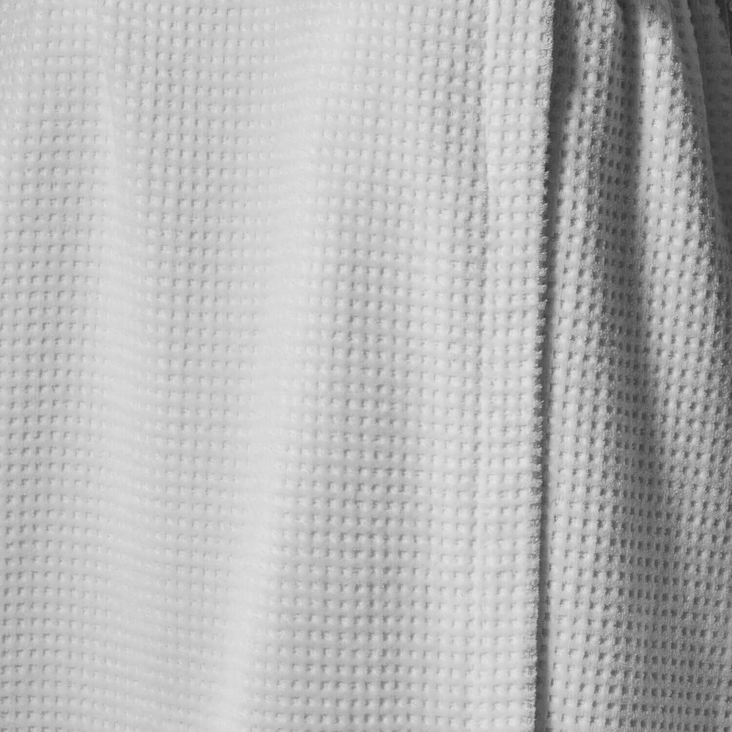 Close-up of a lightweight white velour body wrap, showcasing its textured fabric for comfort and functionality.