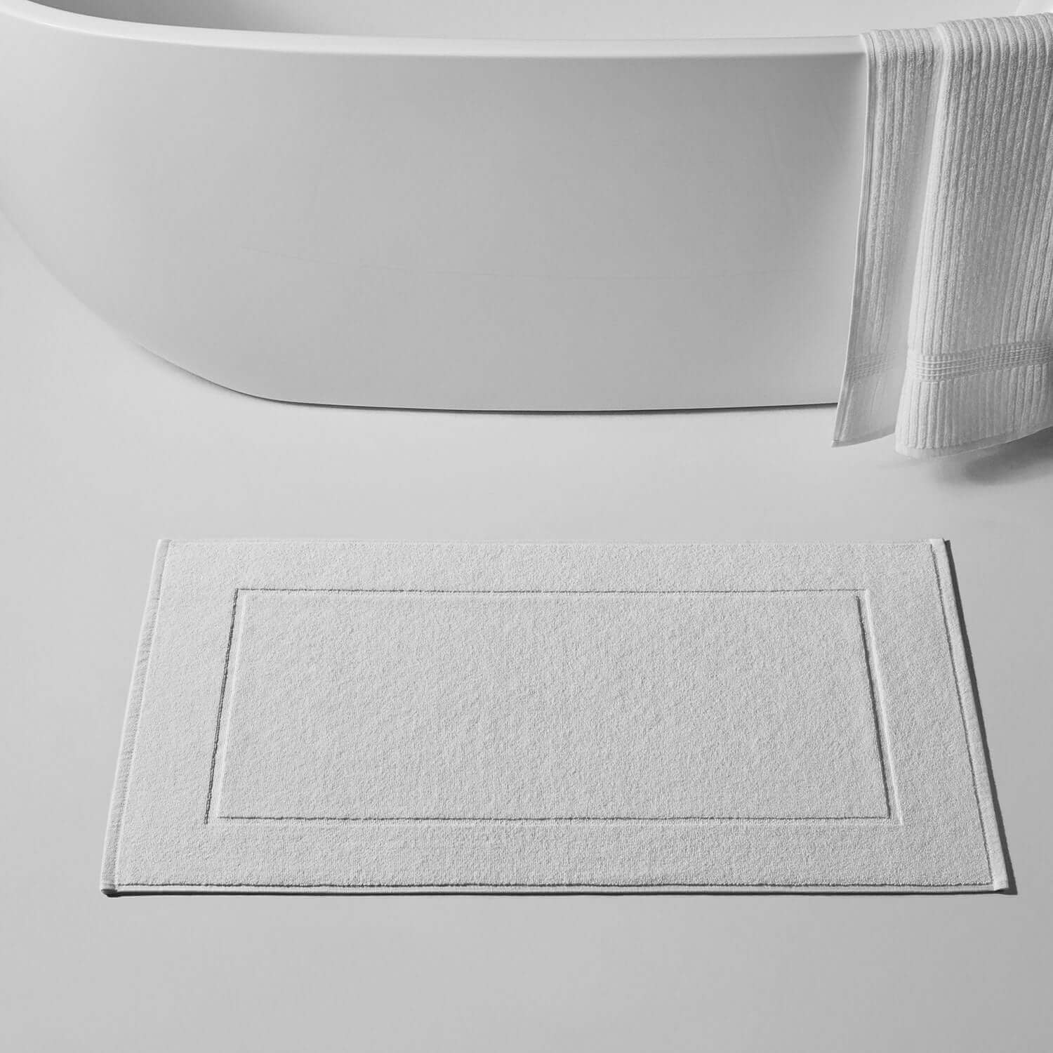 Durable white terry bath mat featuring Slip-Less© technology, perfect for any bathroom décor.