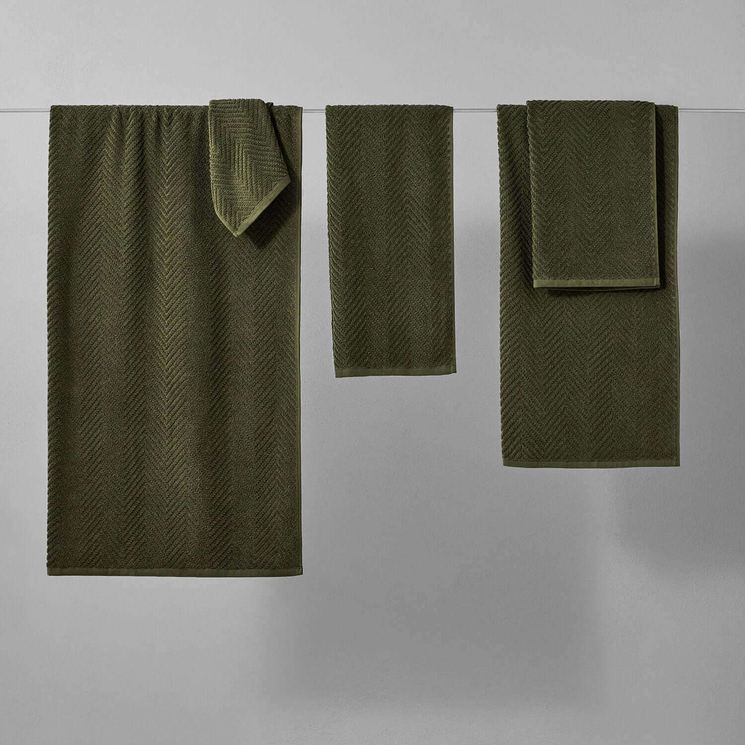 Olive treatment towels set in herringbone pattern, perfect for spas, showcasing durability and vibrant color for mud treatments.