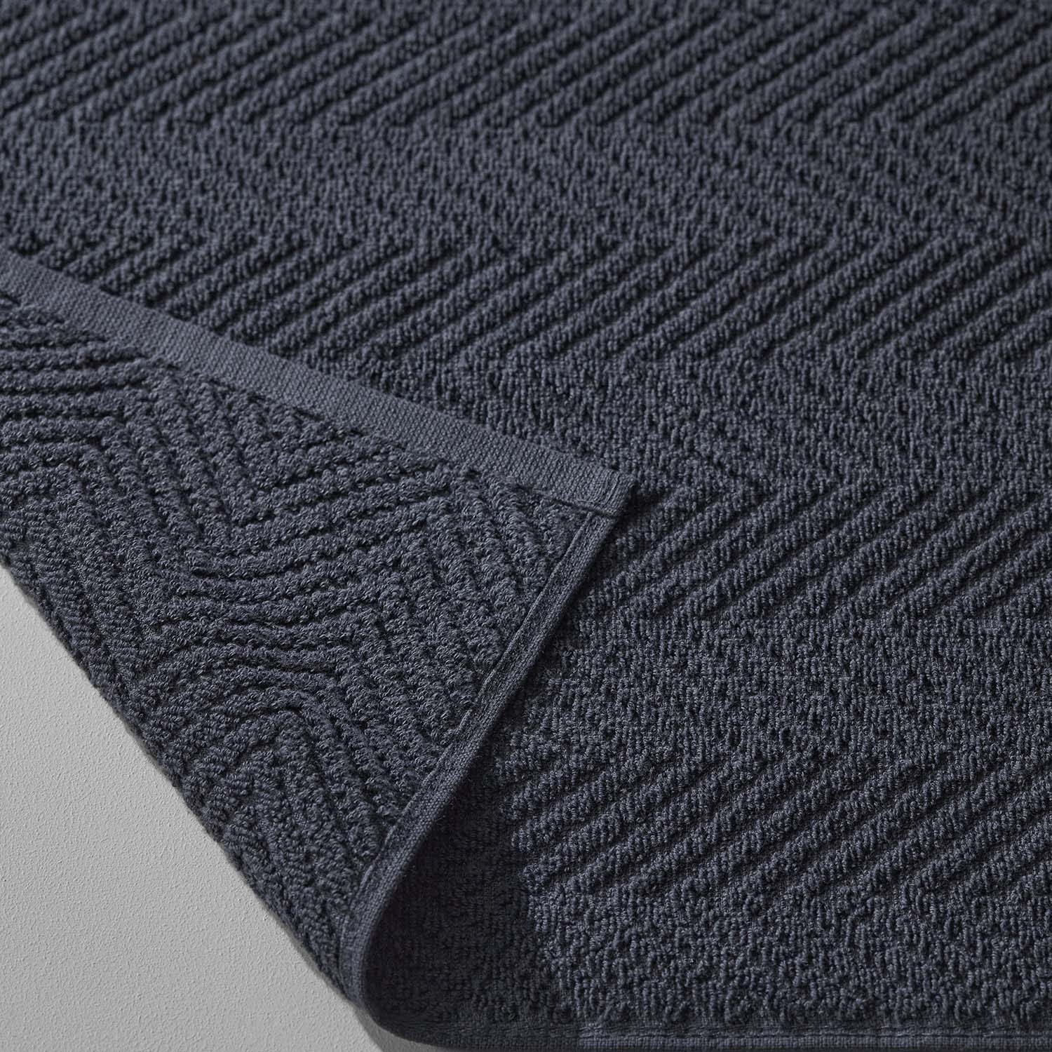 Slate treatment towel showcasing a textured herringbone pattern, perfect for spas and wellness applications.